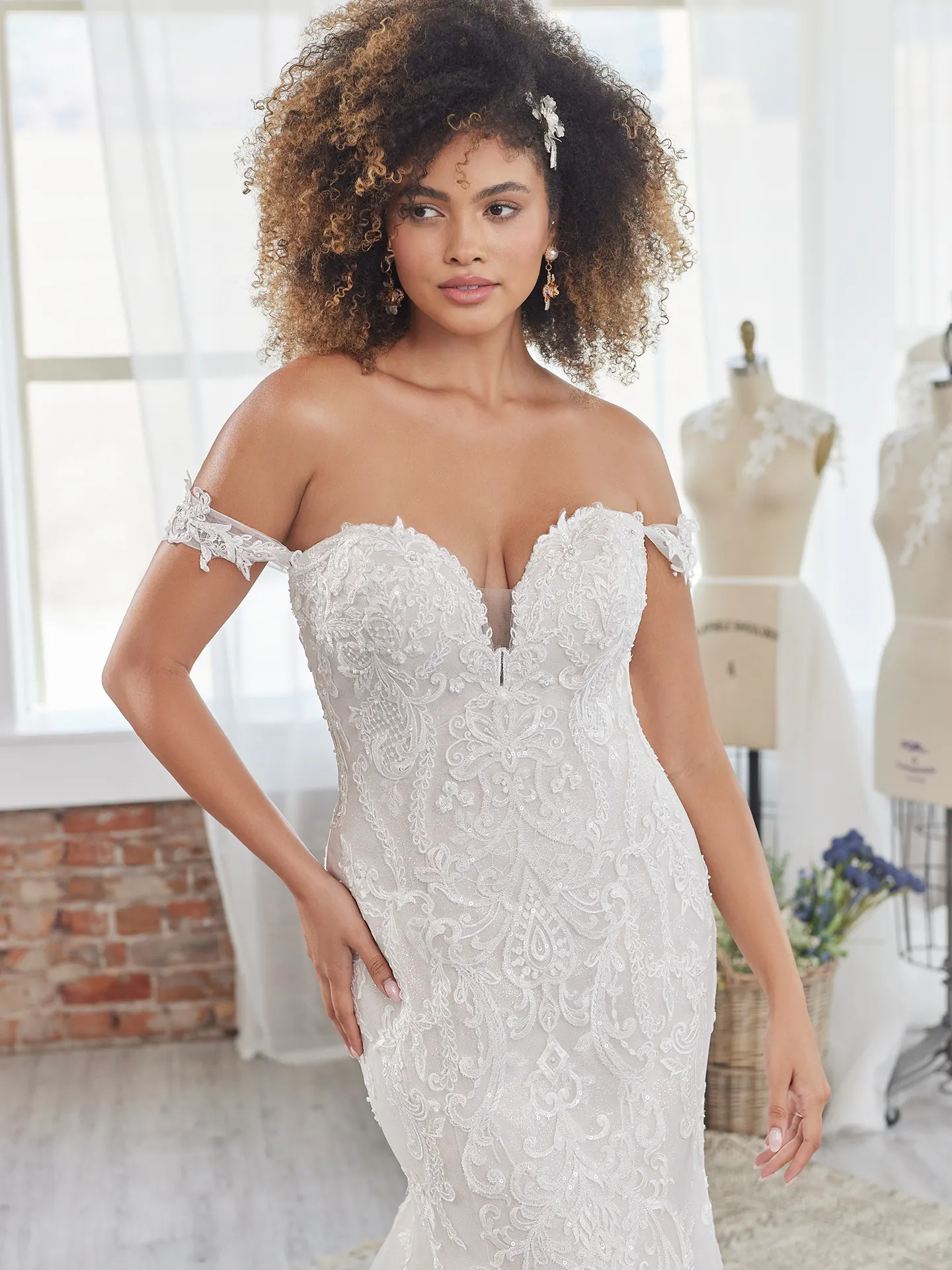 Maggie Sottero Frederique front view off-shoulder lace wedding dress in studio setting