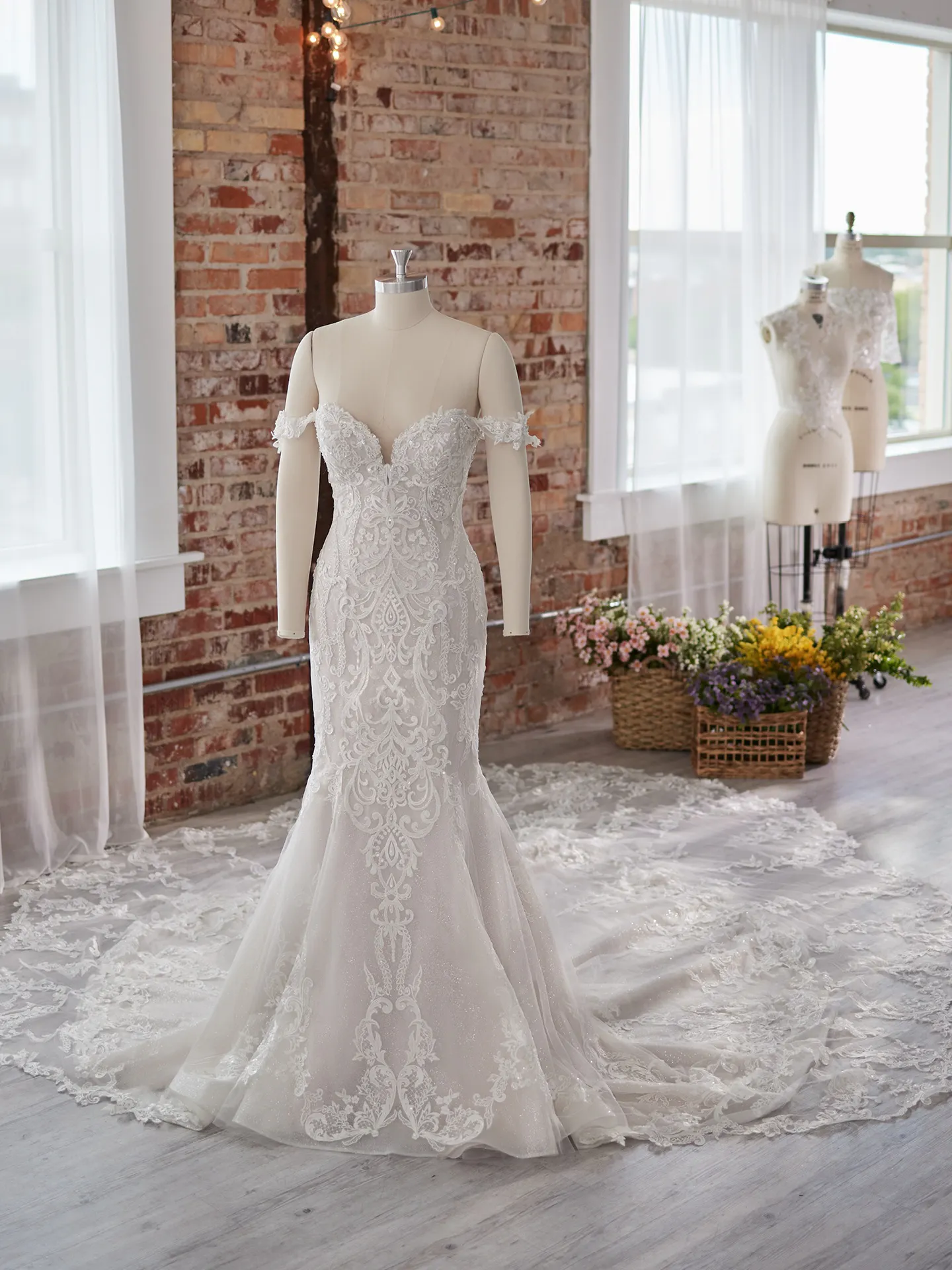 maggie sottero frederique front view off-shoulder lace bridal dress on mannequin in studio