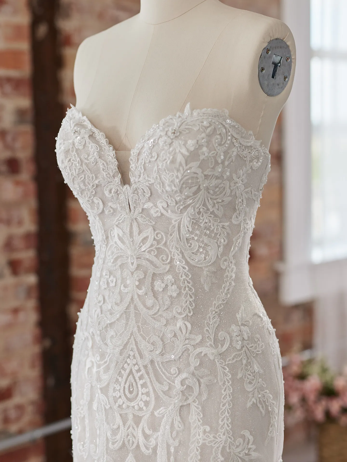 Maggie Sottero Frederique front view lace detail on mannequin