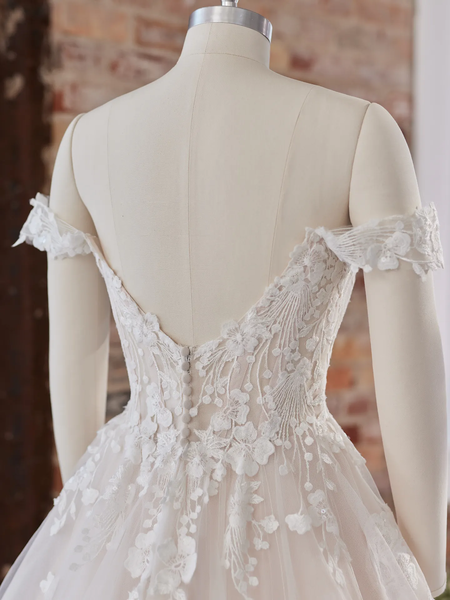 Maggie Sottero Harlem off-the-shoulder gown back view with floral lace detail