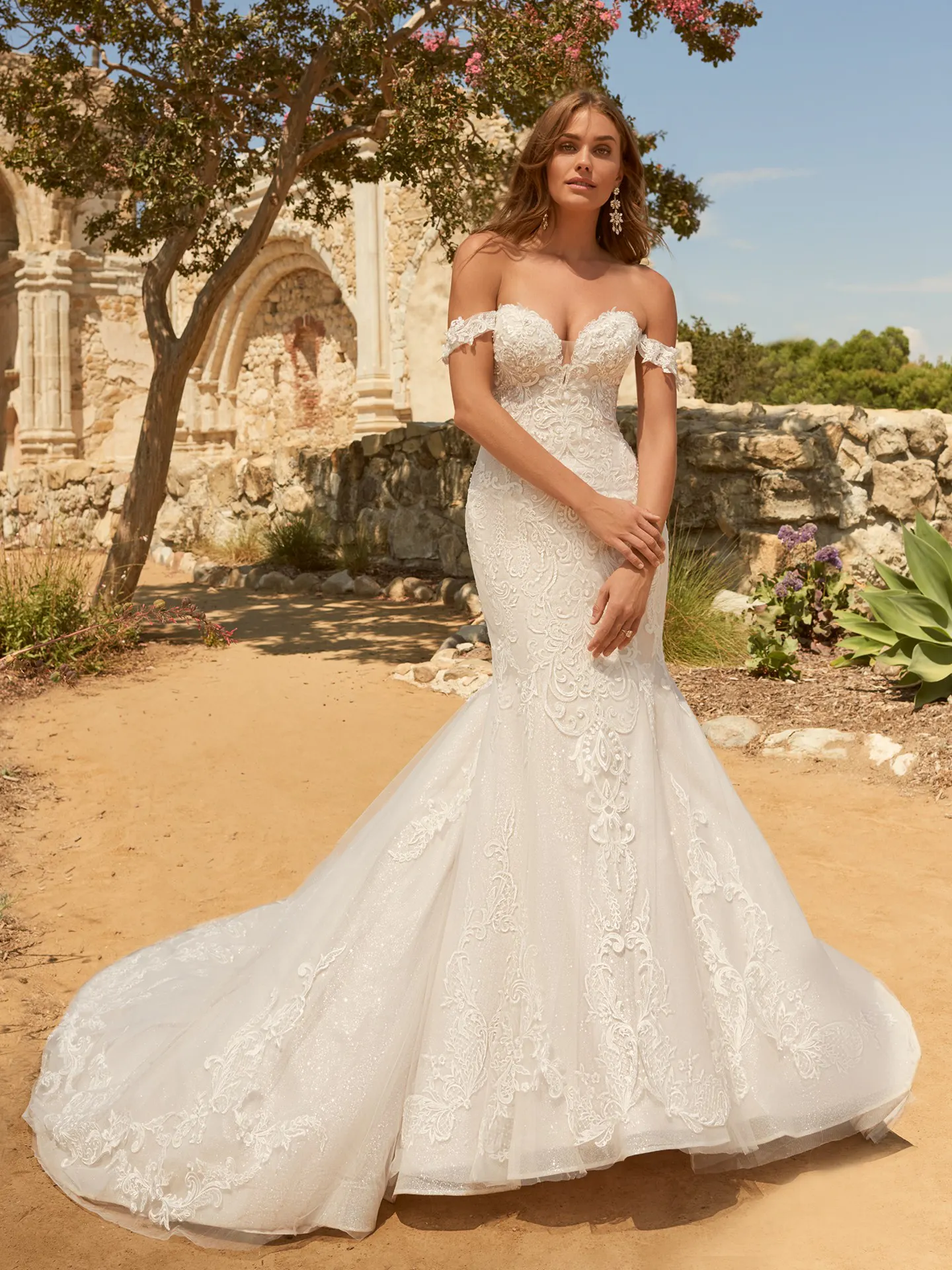 Maggie Sottero Frederique front view elegant off-the-shoulder bridal dress in garden setting
