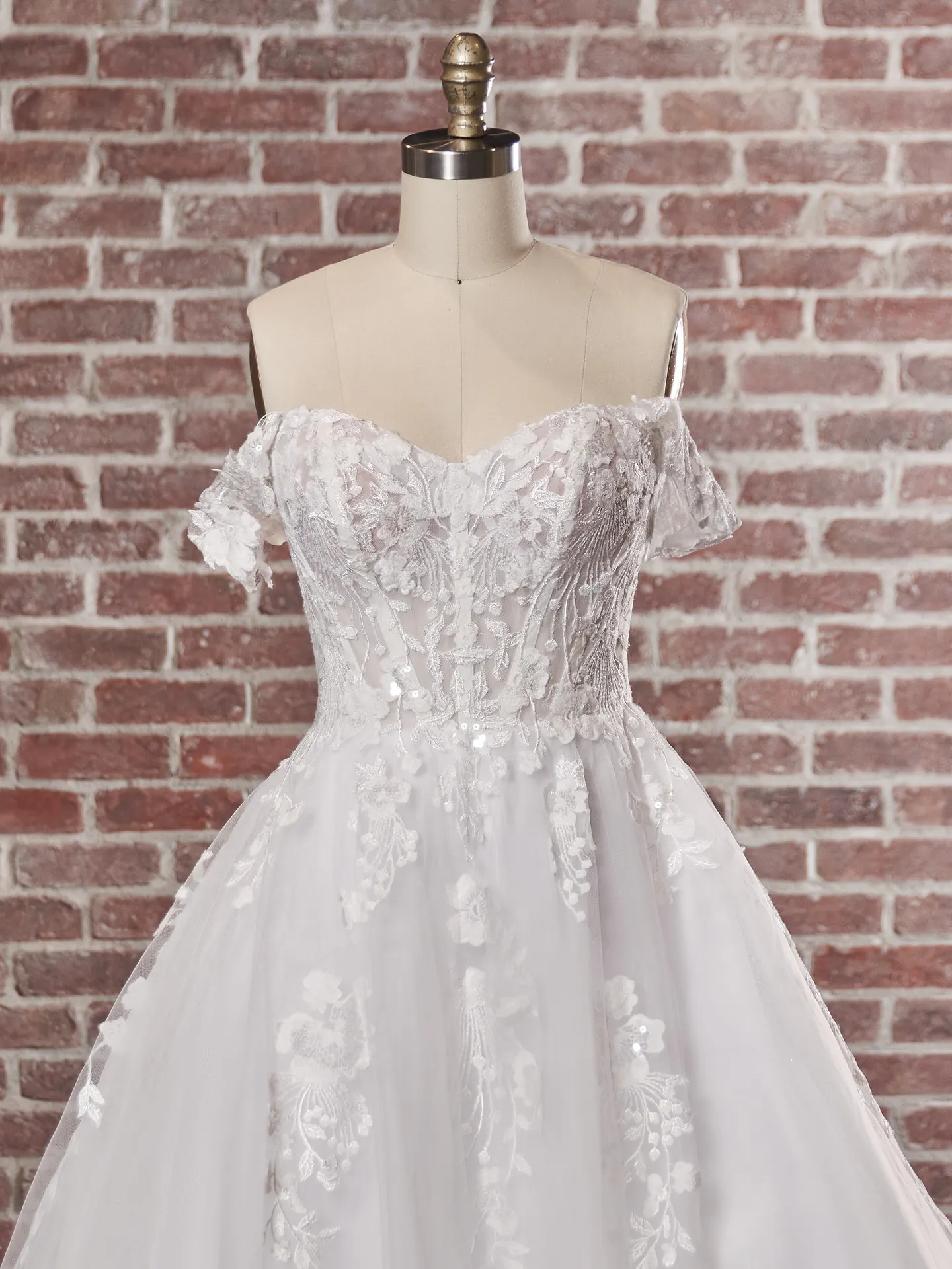 Maggie Sottero Harlem wedding gown front view, off-the-shoulder lace design.