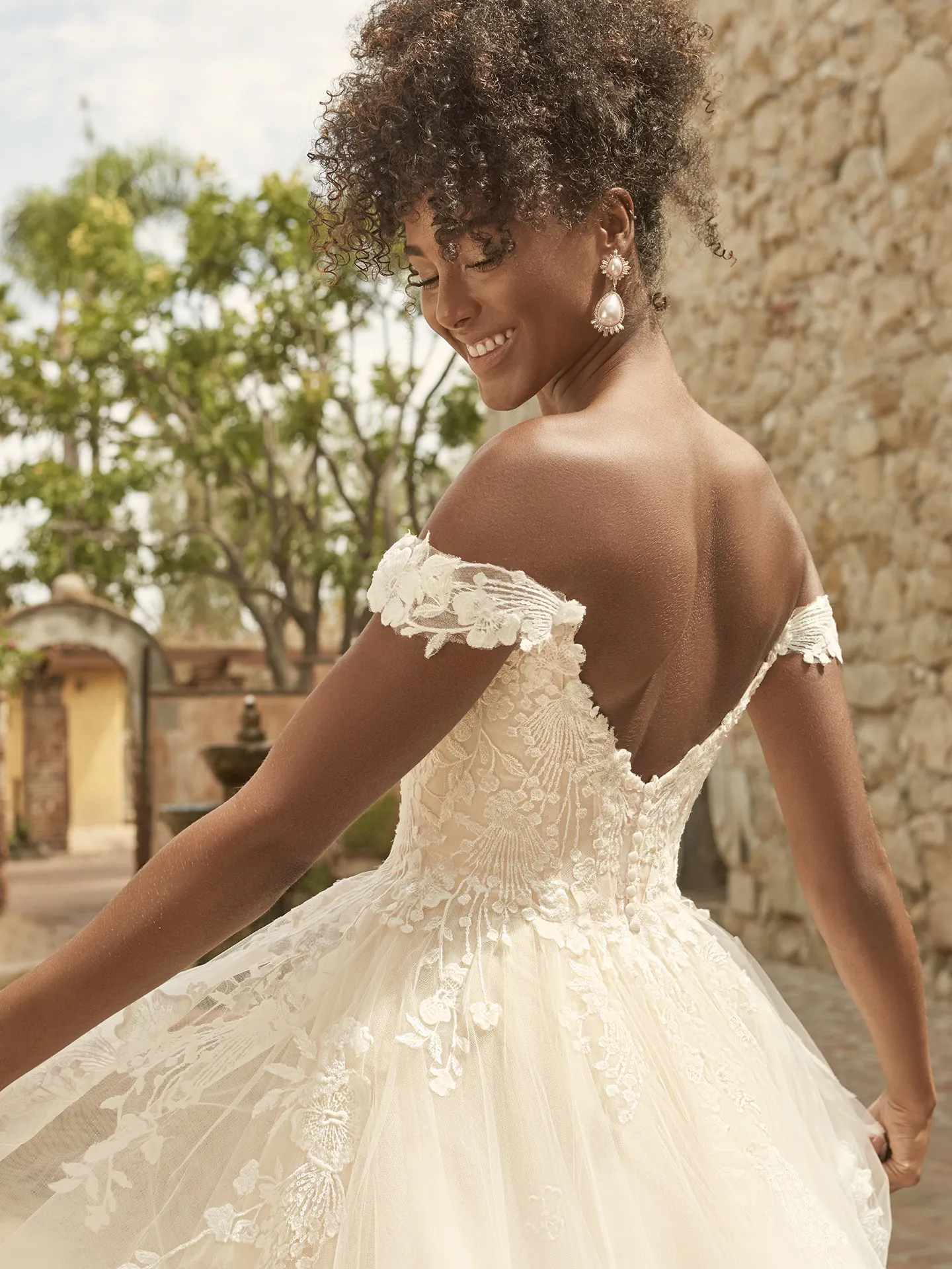 Maggie Sottero Harlem back view lace off-shoulder gown outdoors