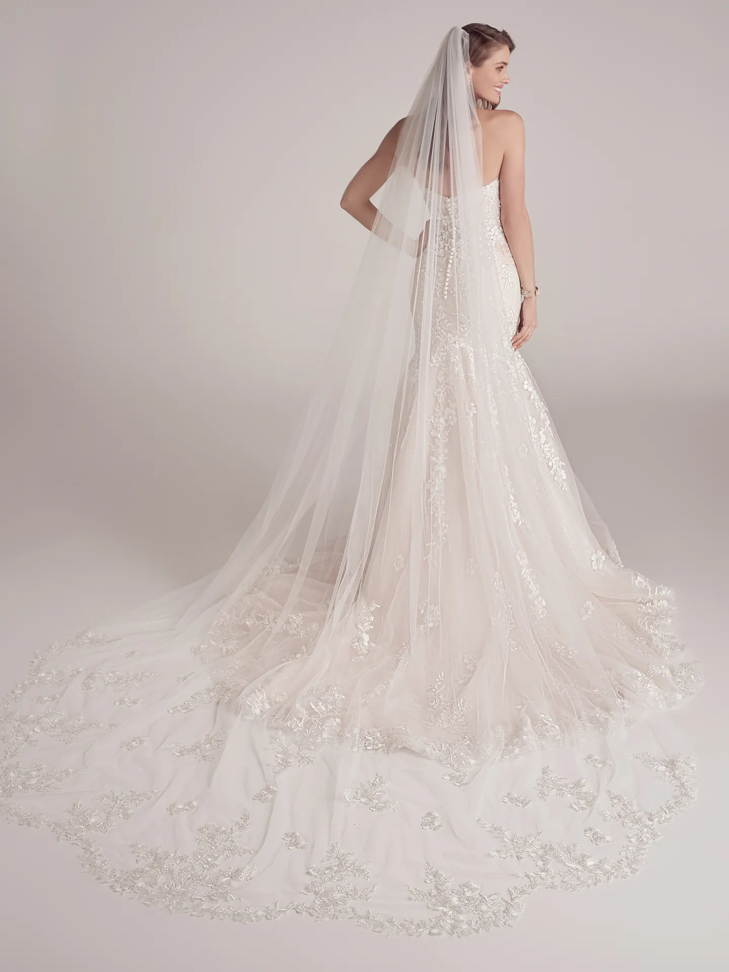 Maggie Sottero Lennon back view of floral beaded mermaid bridal gown with long train