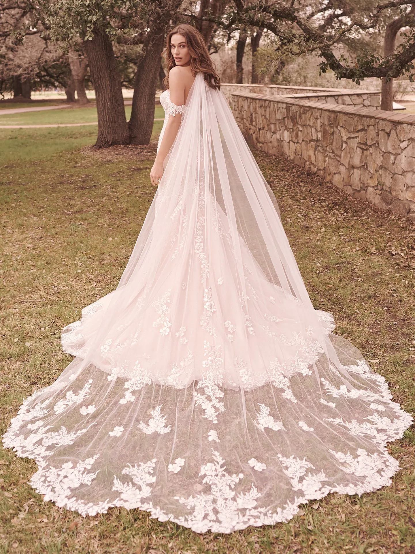 Lennon Mermaid Gown back view with floral beaded train in outdoor setting