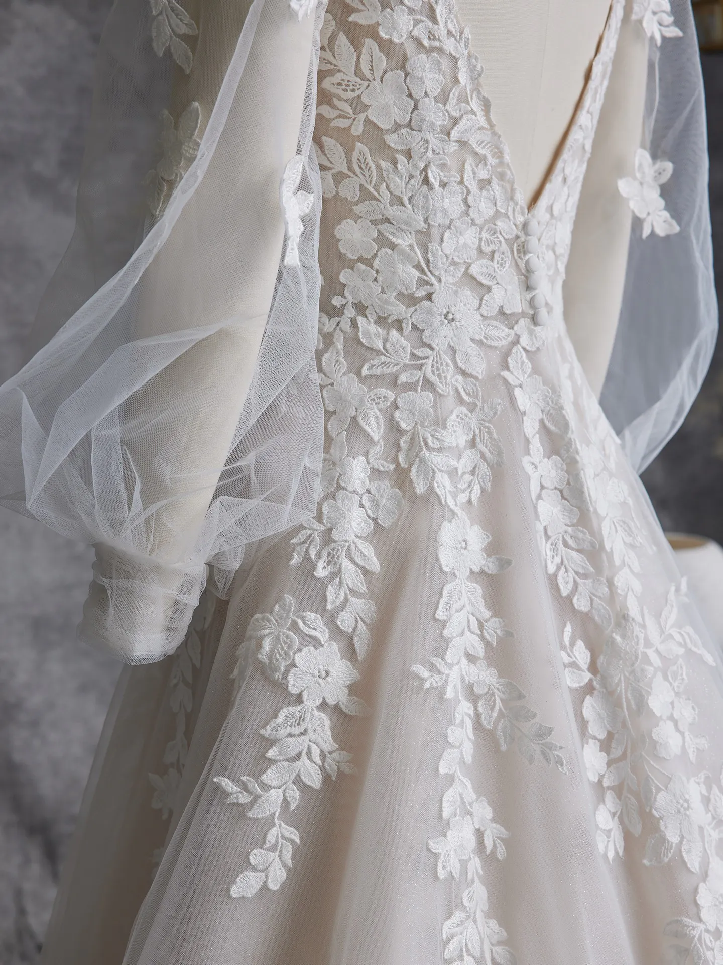 Maggie Sottero Alexandria back view with floral lace and bishop sleeves.