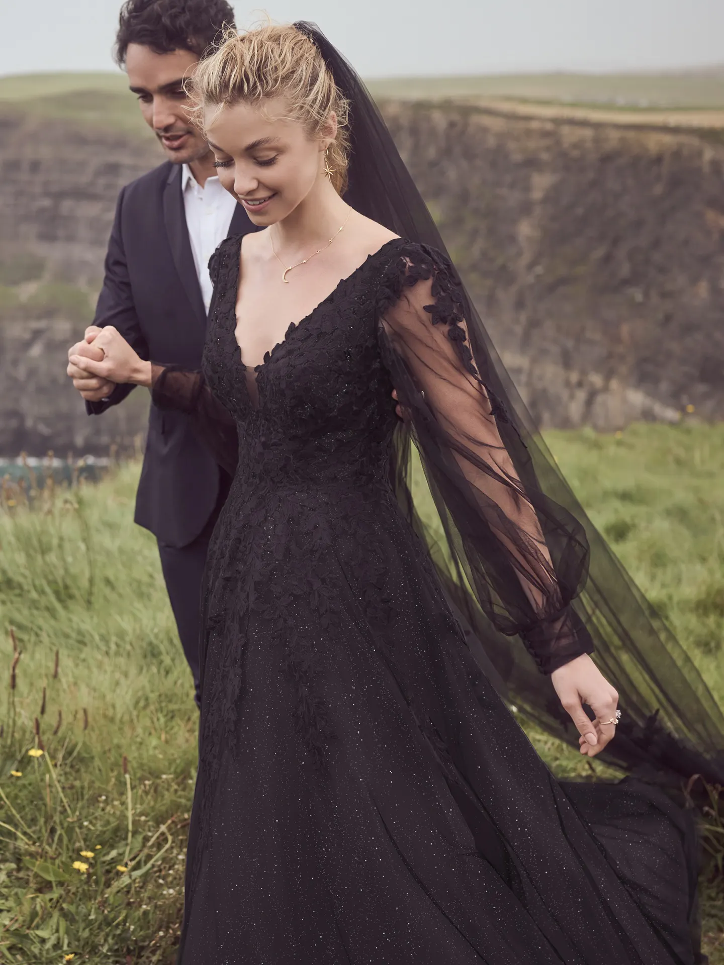 Maggie Sottero Alexandria black dress, bishop sleeves, outdoor setting.