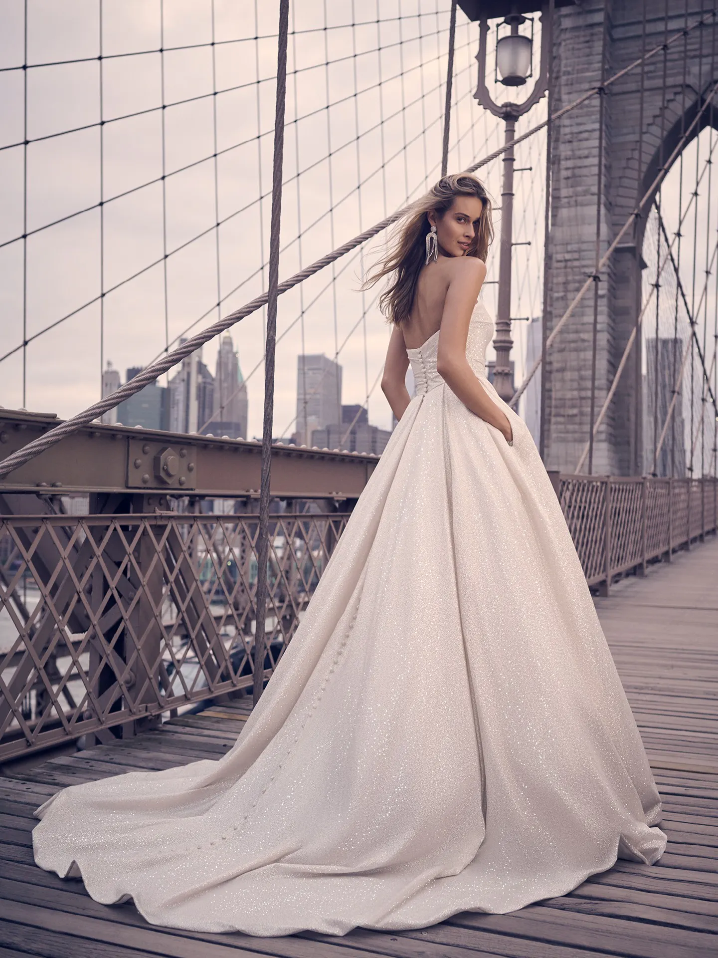 Anniston shimmery ballgown back view on bridge Maggie Sottero