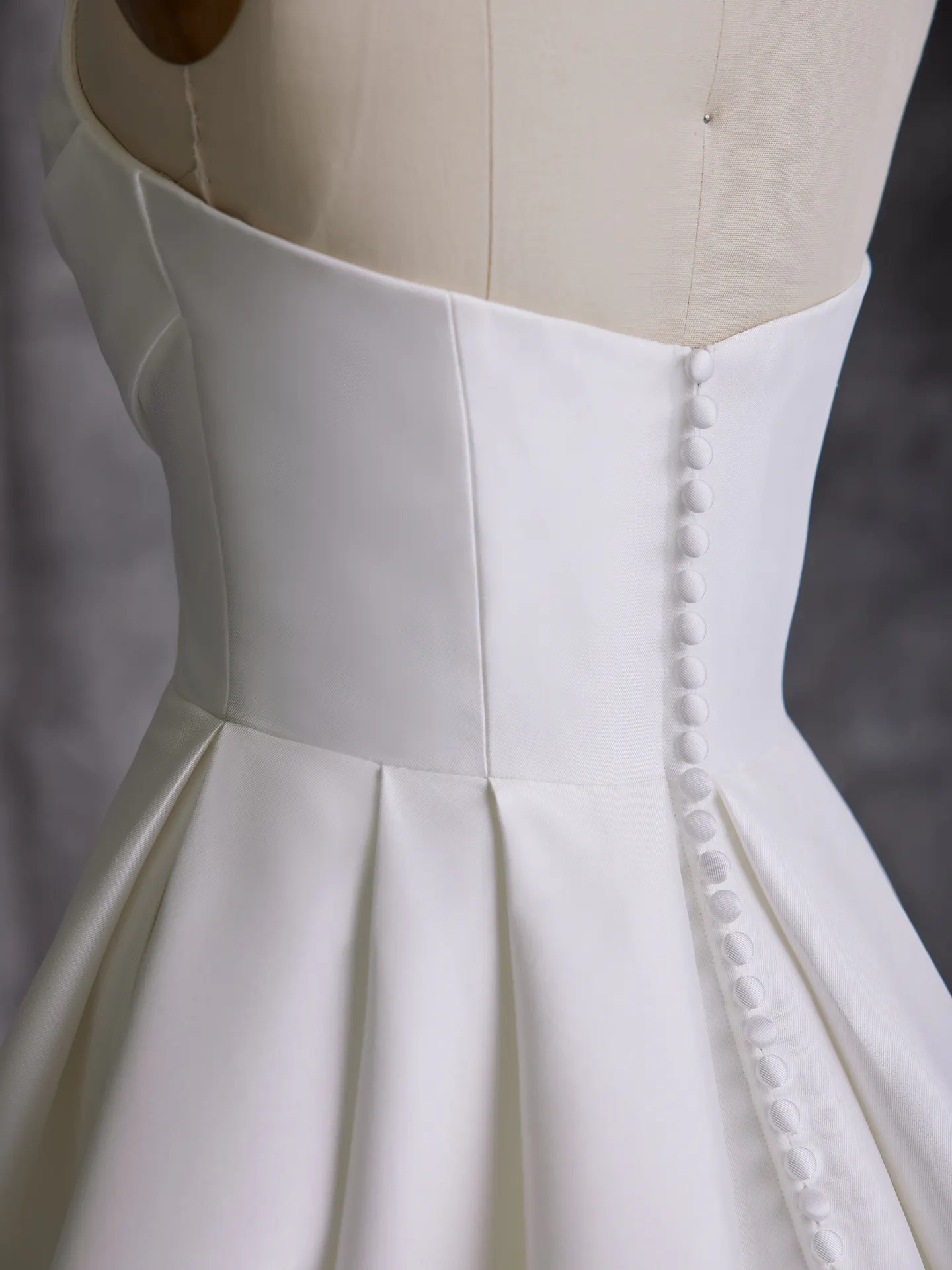 Sottero and Midgley Aspen side view white A-line dress with button detail.