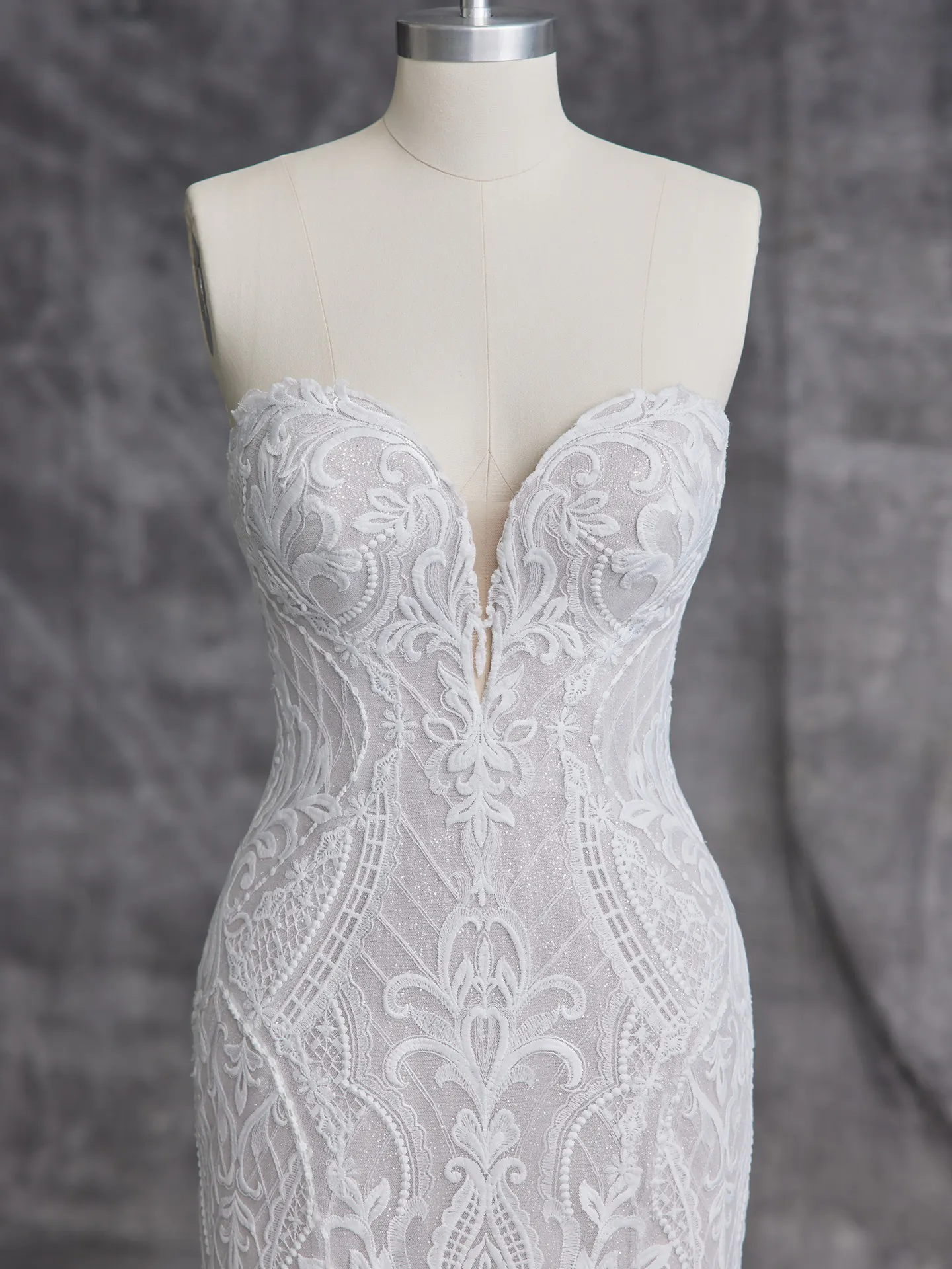 Sottero and Midgley Bronson front view fit-and-flare lace bridal gown on mannequin.