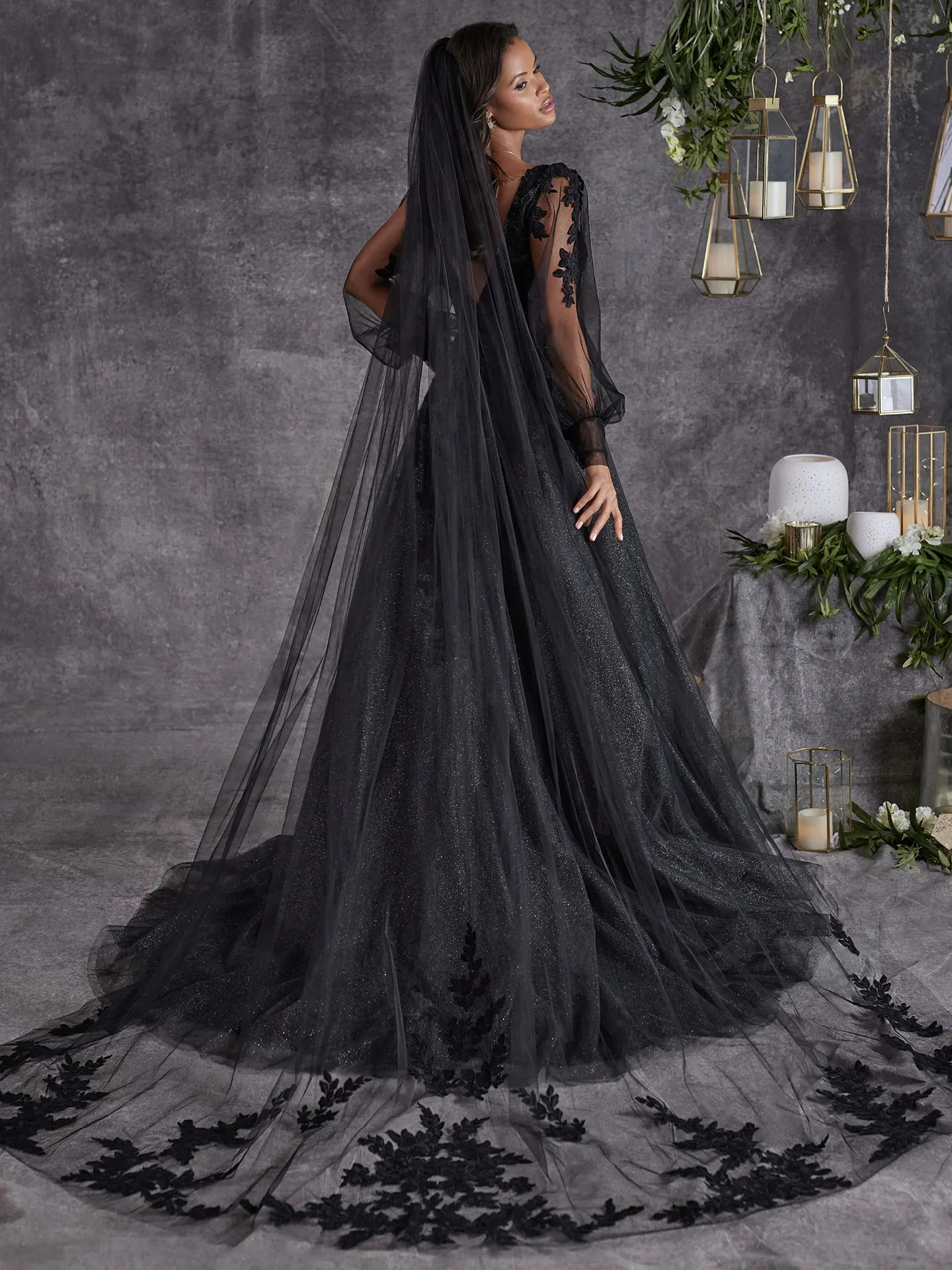 Maggie Sottero Alexandria back view black dress with sheer bishop sleeves and floral lace.