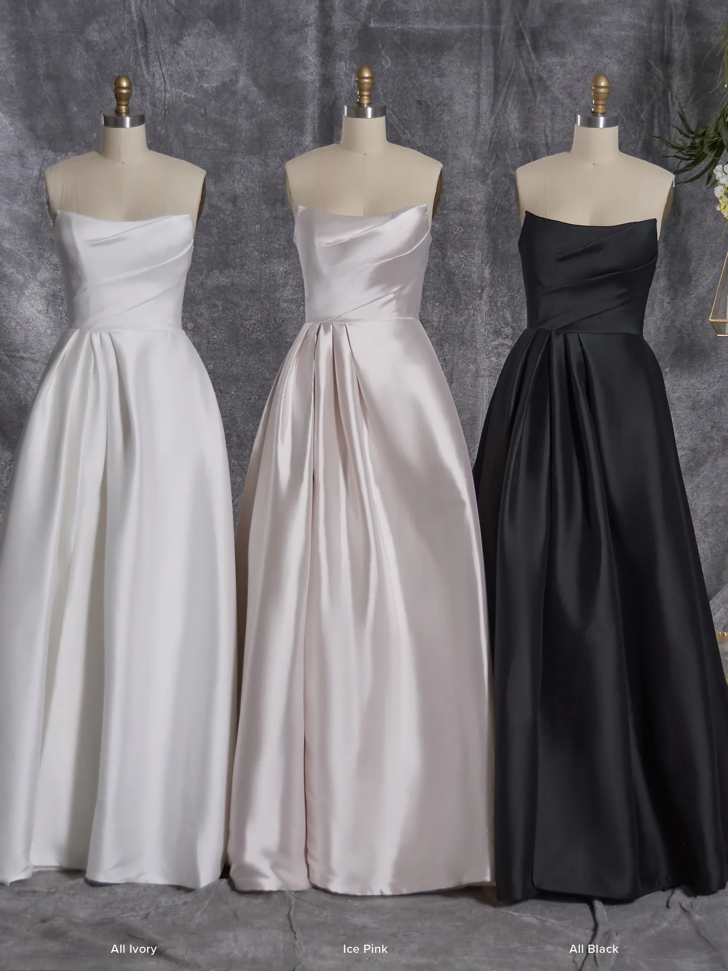 Sottero and Midgley Aspen A-Line strapless dresses in ivory, pink, and black on mannequins.