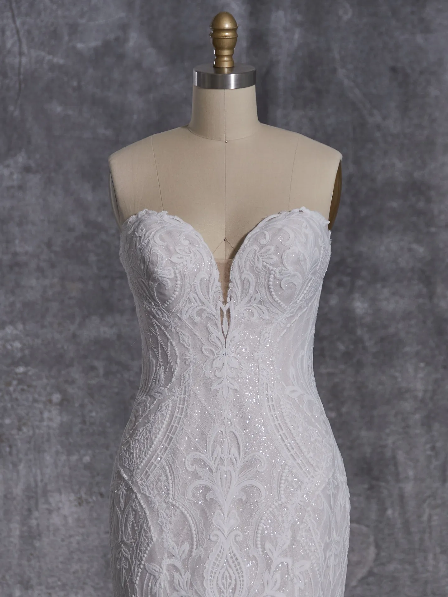 Sottero and Midgley Bronson gown on mannequin, intricate lace design, front view.