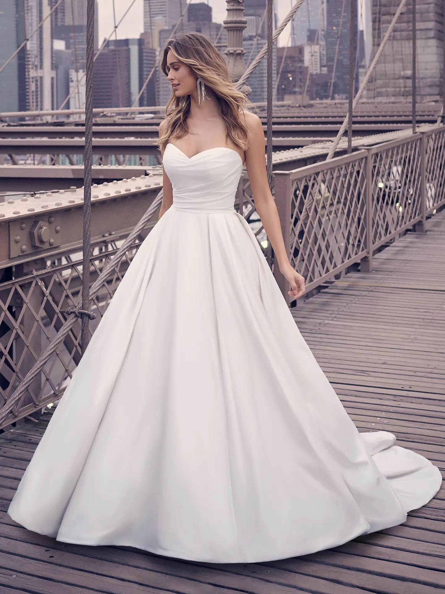 Anniston Marie satin ballgown front view on a city bridge Maggie Sottero