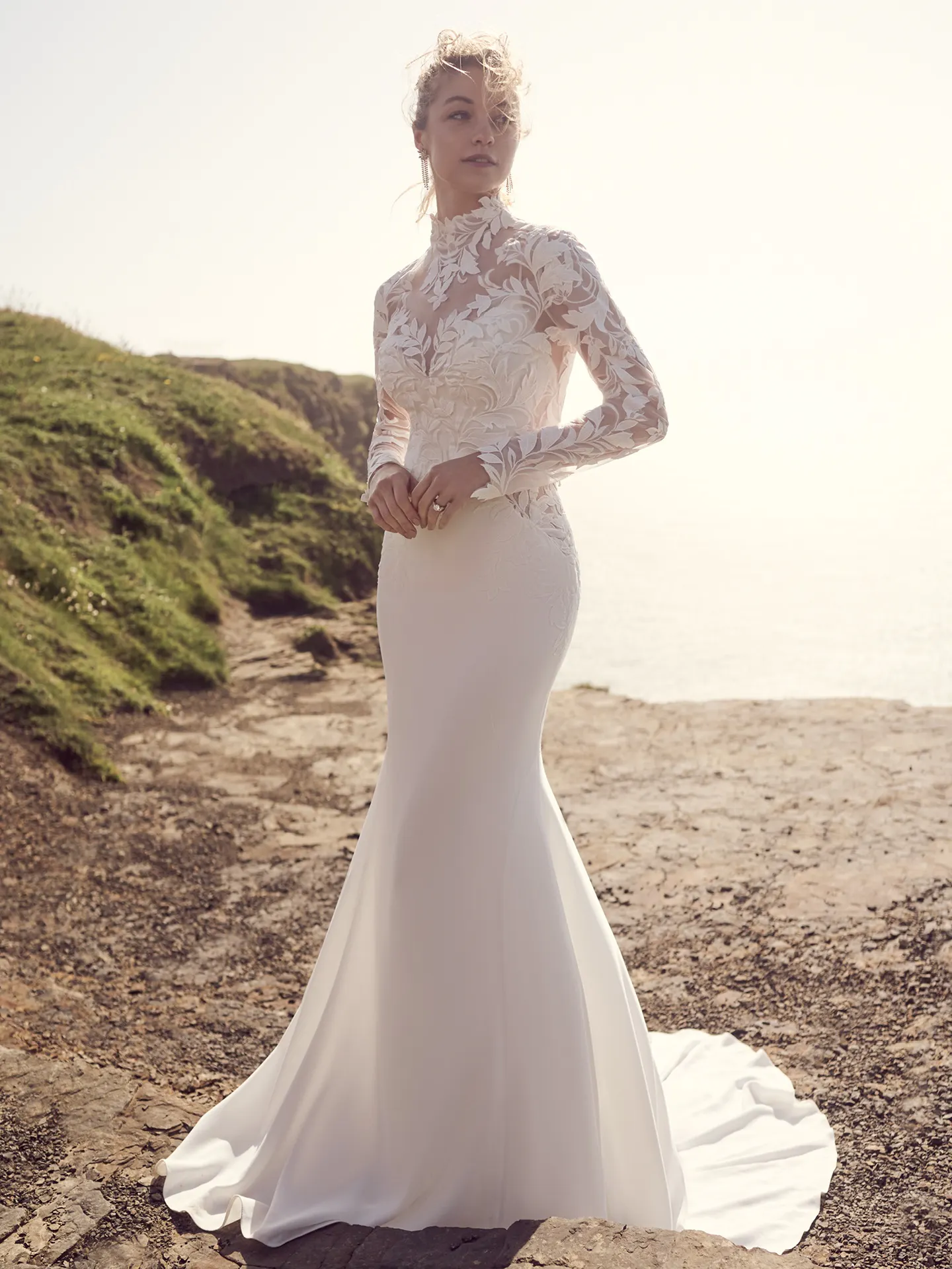 Rebecca Ingram Dionne front view lace wedding dress on rocky coast.