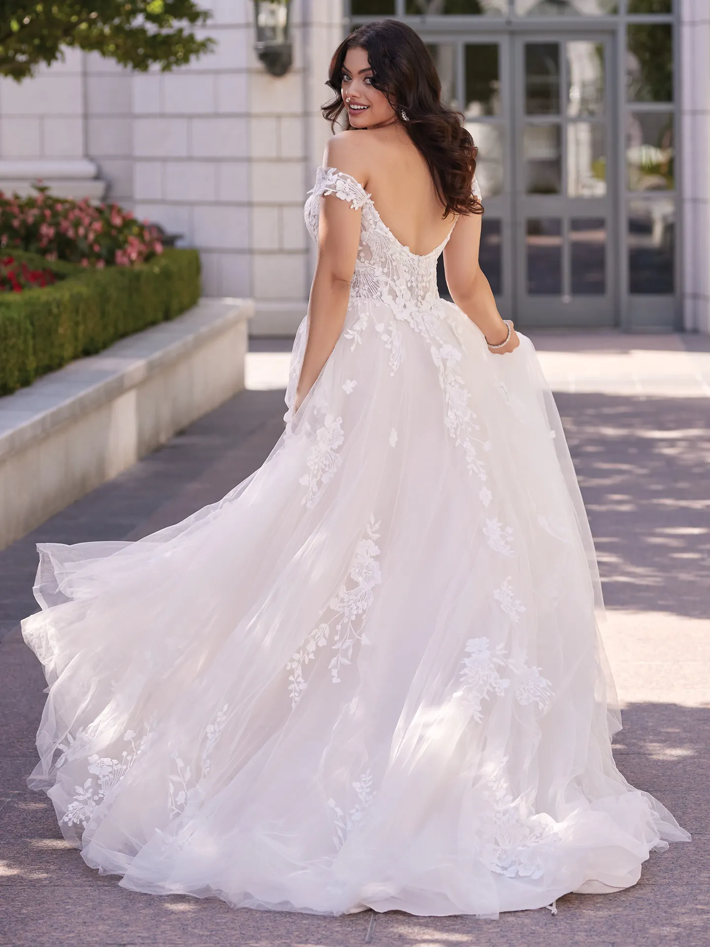 Maggie Sottero Harlem back view off-the-shoulder gown with floral lace outdoors