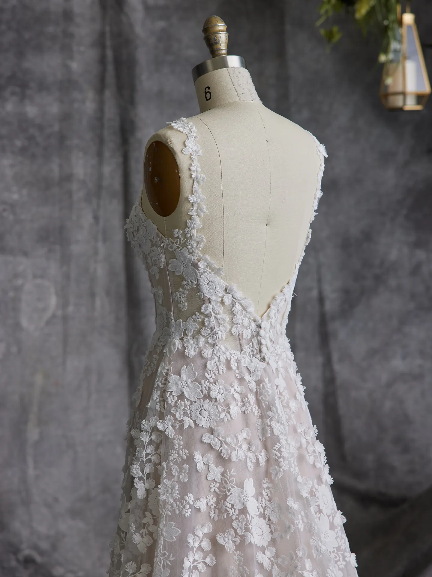 Ladonna floral wedding dress back view on mannequin in studio setting