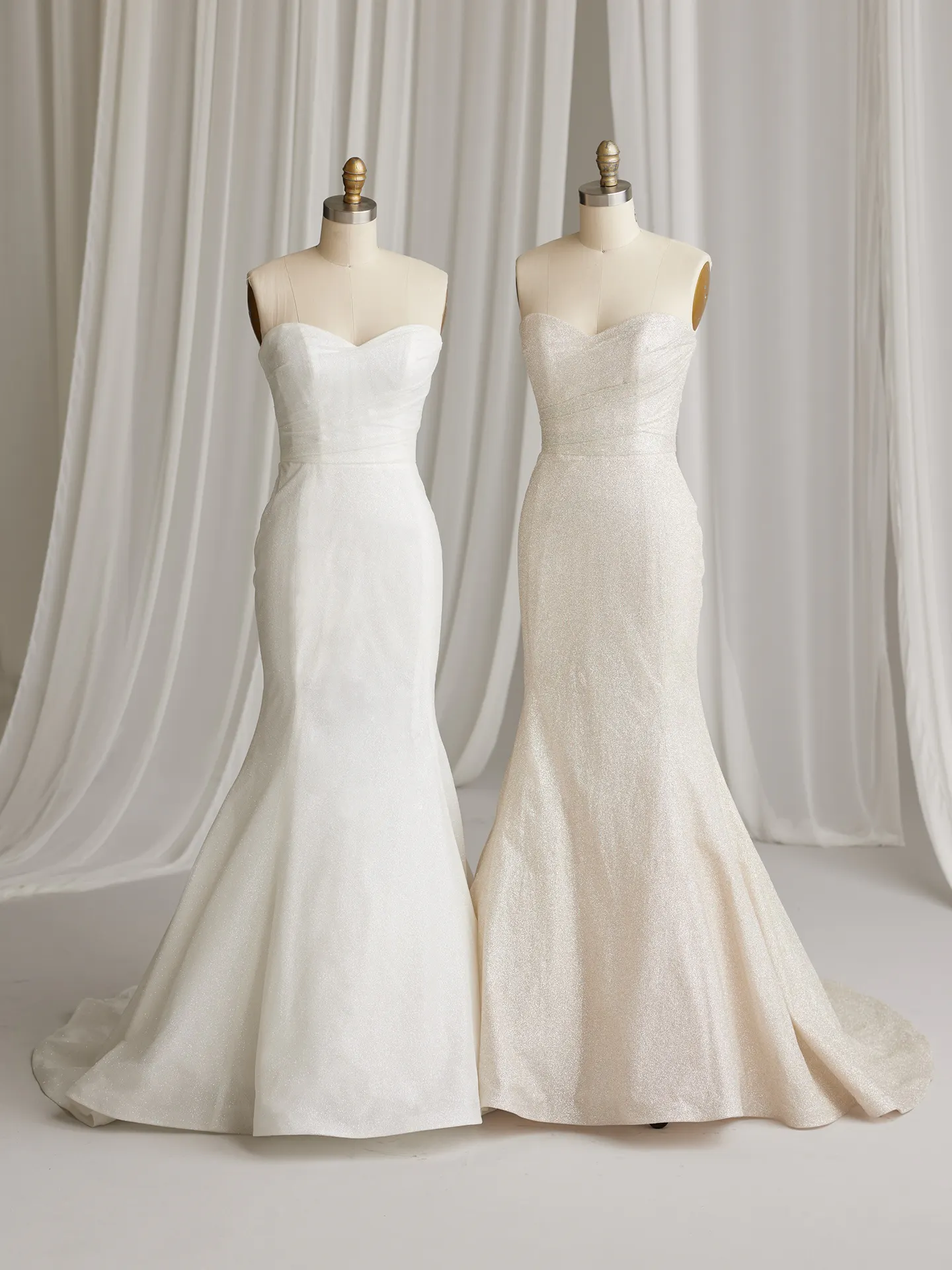 Anniston Lane glitter fit-and-flare gowns on mannequins against draped background.