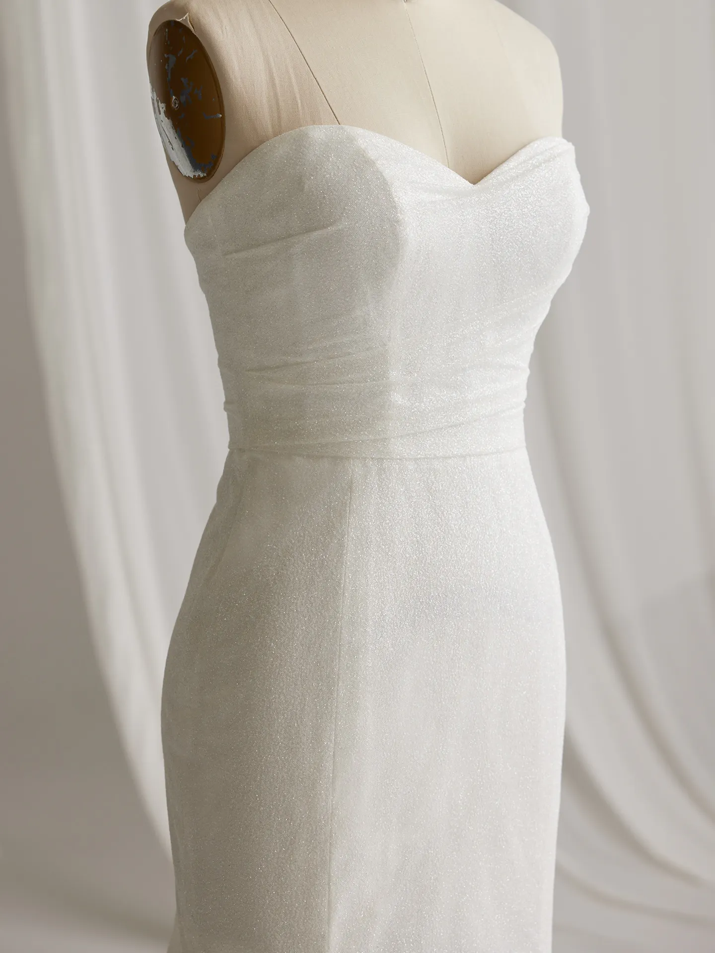 Maggie Sottero Anniston Lane glittery bridal gown on mannequin side view