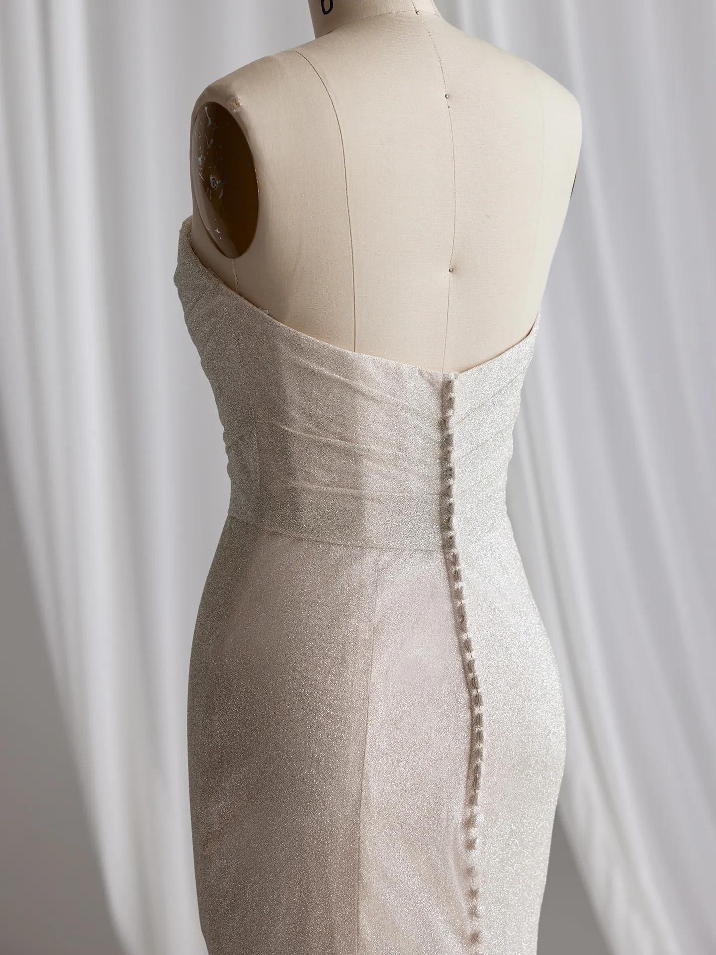 Maggie Sottero Anniston Lane back view glitter fit-and-flare gown on mannequin