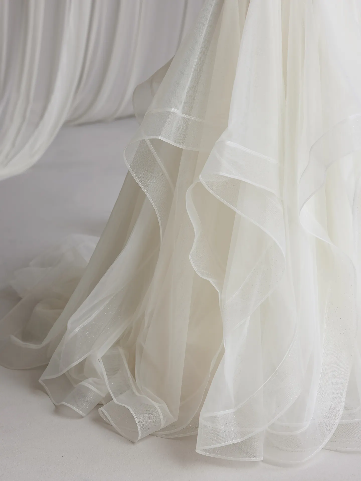 Anniston Lane fit-and-flare gown details with layered tulle, Maggie Sottero.