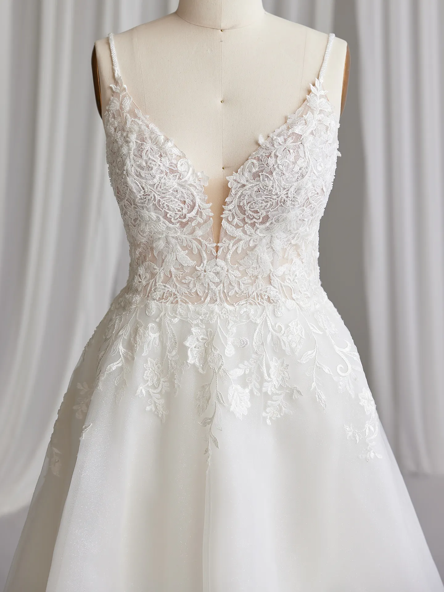 Rebecca Ingram Lizzy front view gown with lace V-neck and sequin detail.