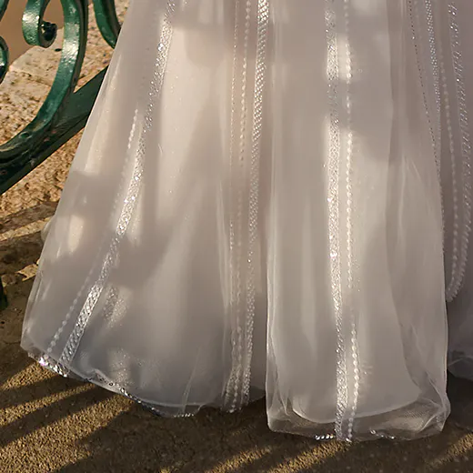 Sottero and Midgley Positano beaded gown bottom detail near railing