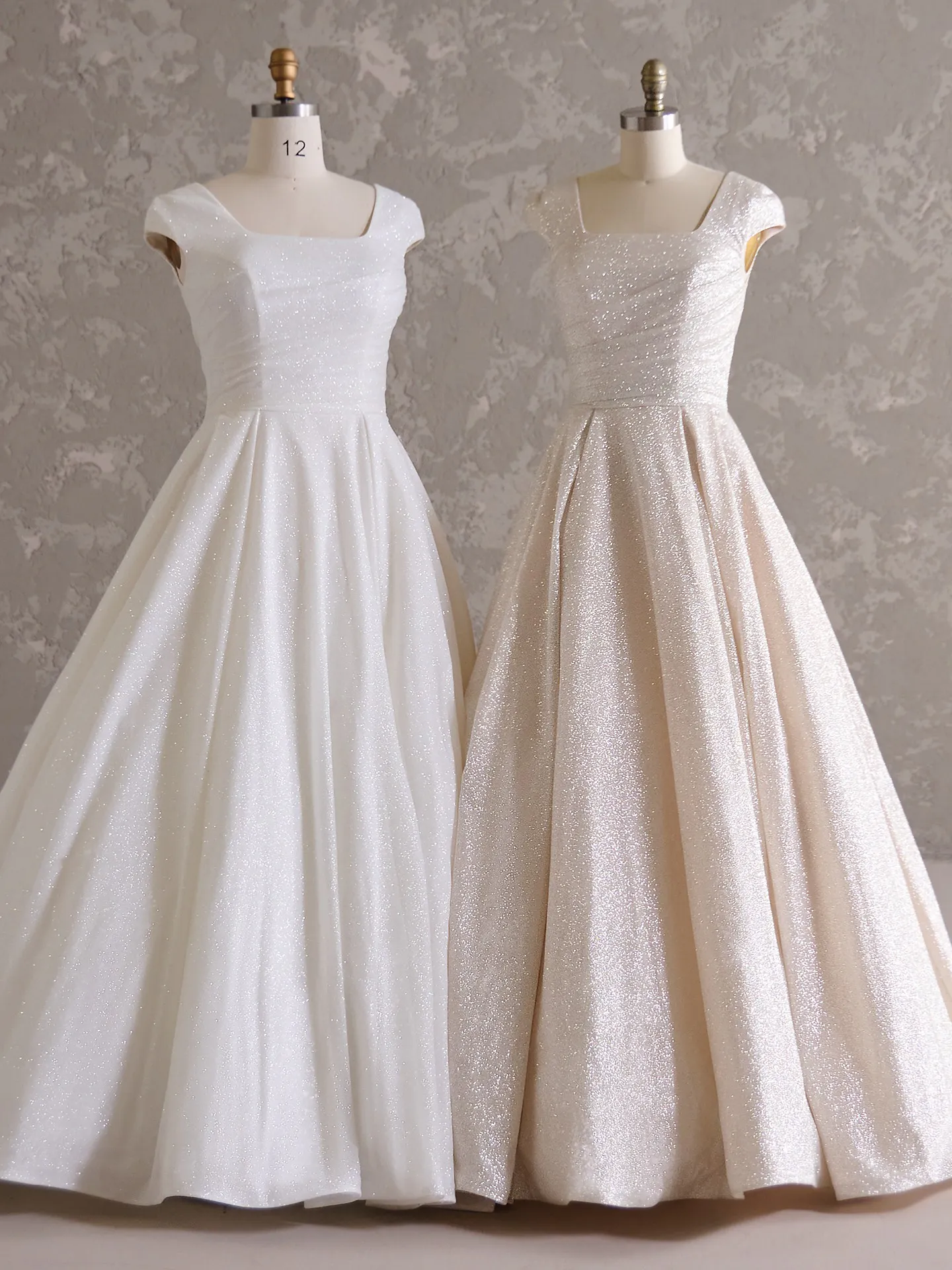 Anniston Leigh bridal gowns with glitter tulle on mannequins.