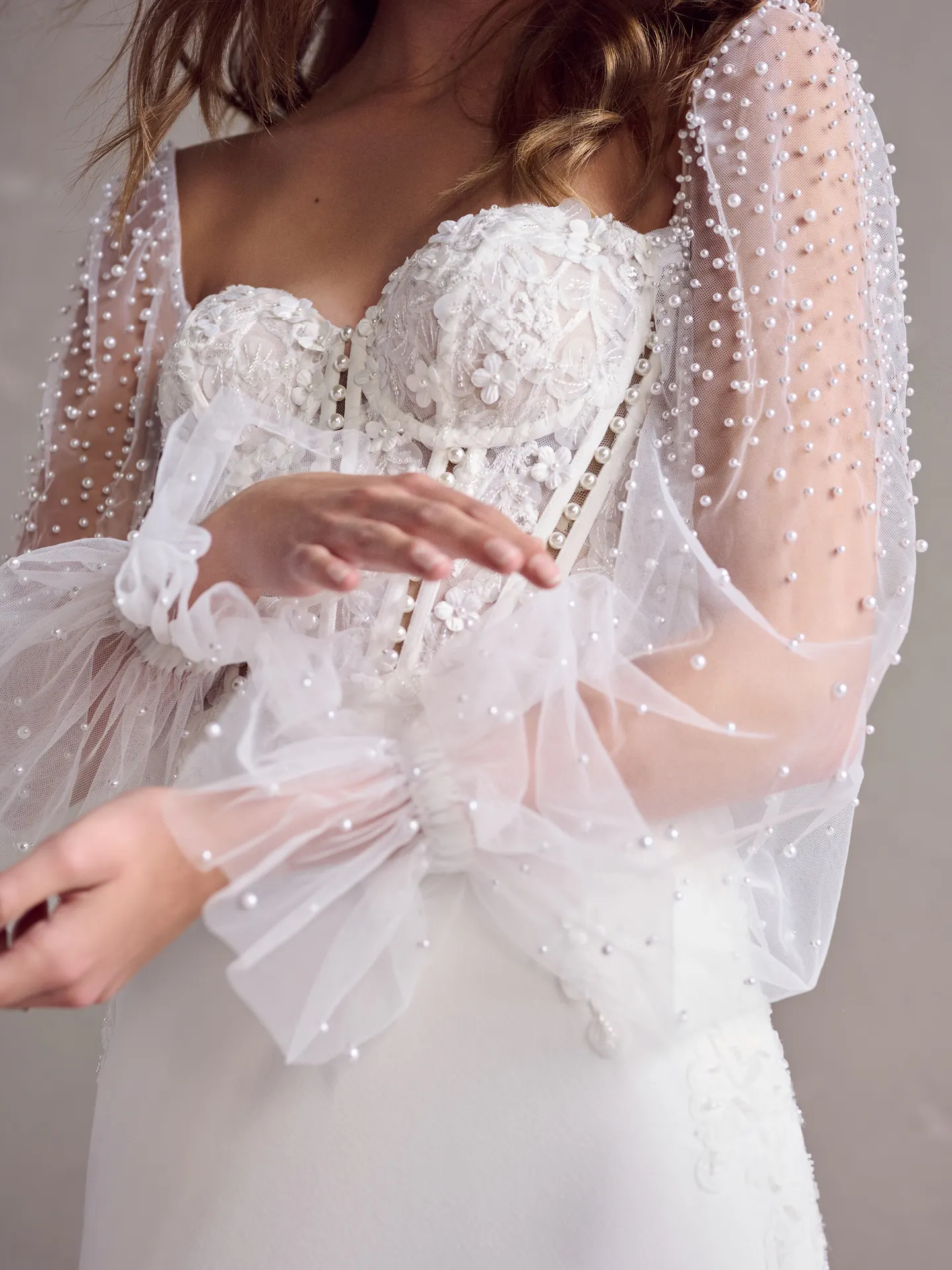 Maggie Sottero wedding dress, illusion poet sleeves, close-up view.