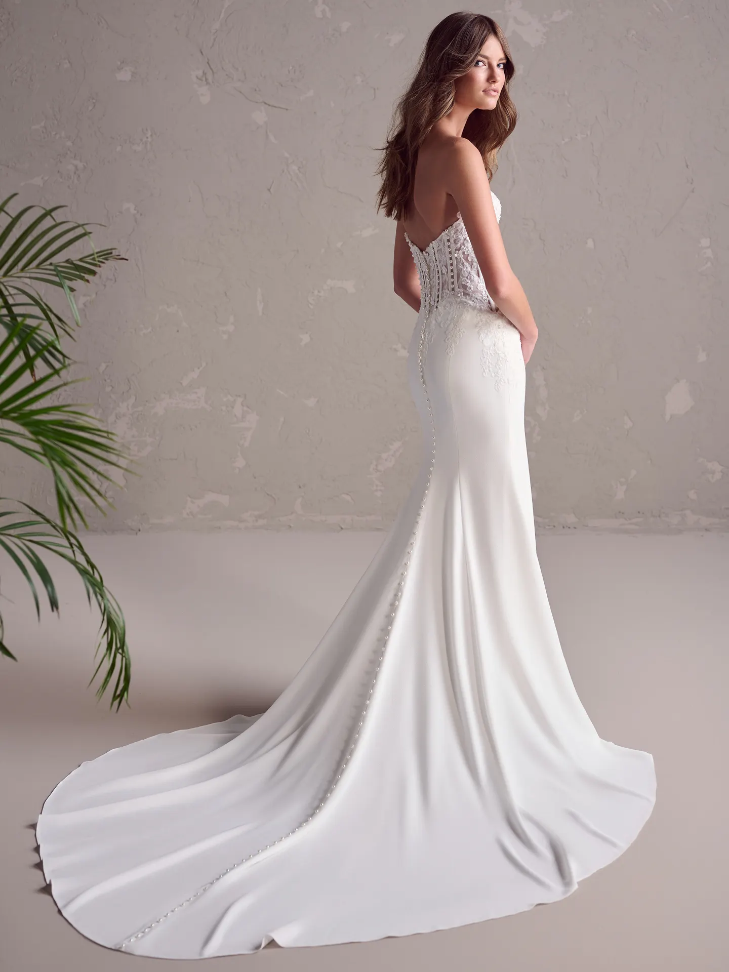 Maggie Sottero Doritte back view crepe wedding dress with pearl detail.