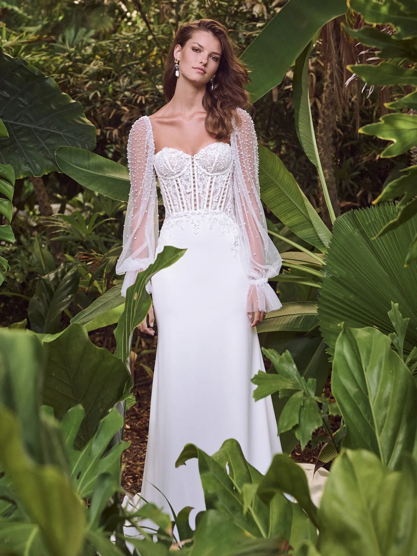 Maggie Sottero Doritte front view, pearl and crepe dress with sheer sleeves in lush greenery.