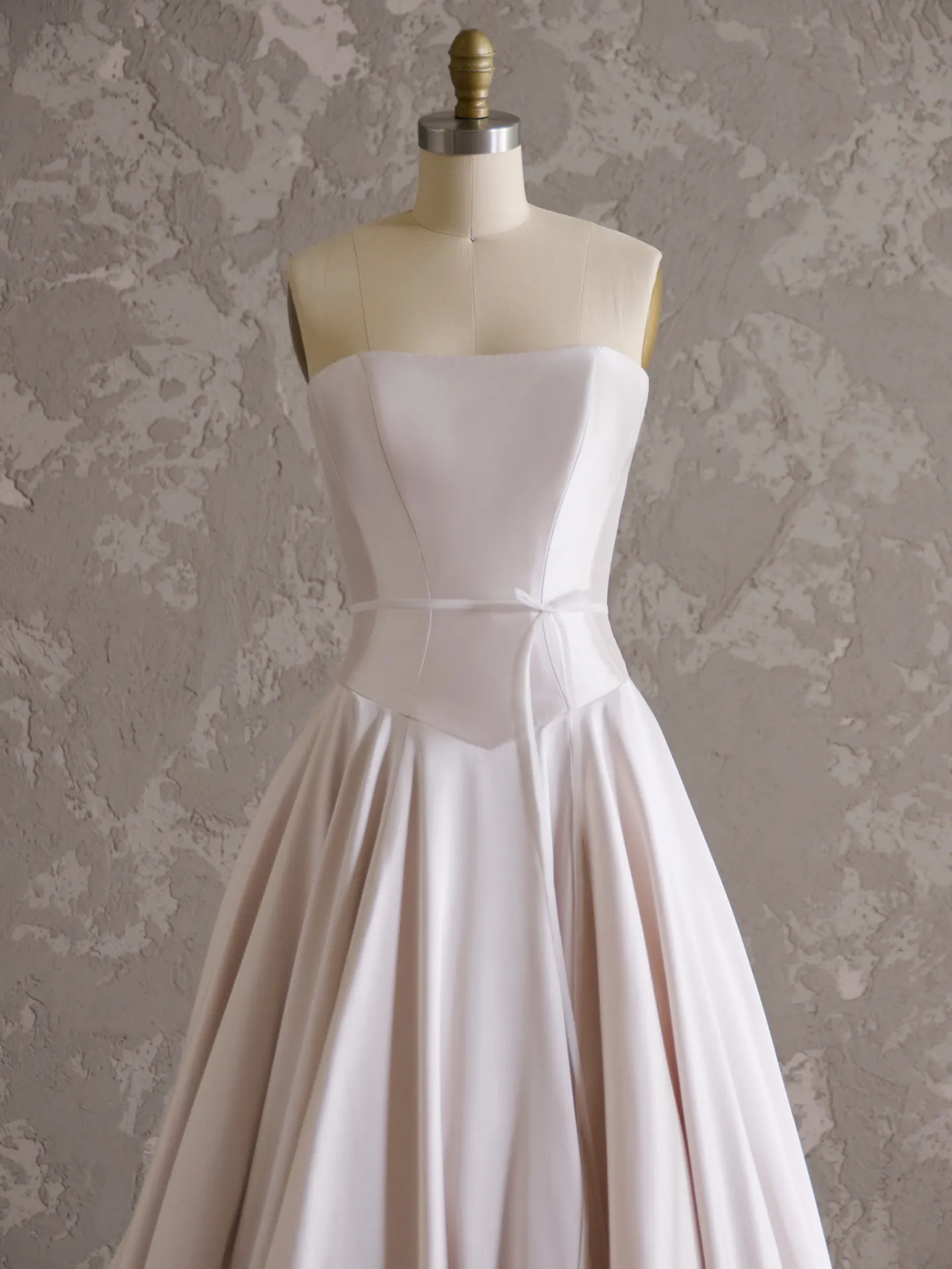 Emmanuelle strapless wedding dress front view on mannequin.