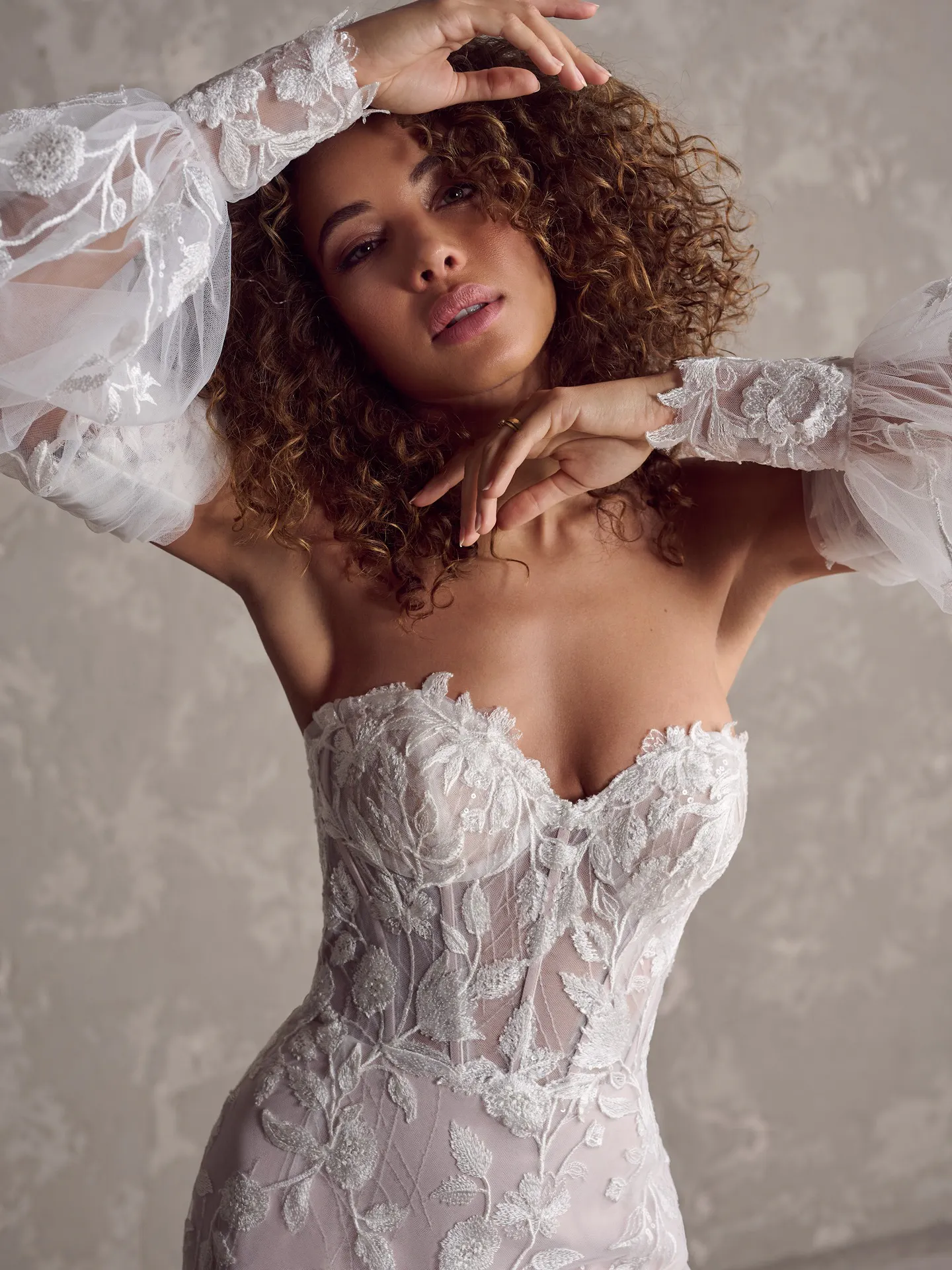 Maggie Sottero Fairchild front view lace bridal gown with embroidered tulle sleeves.