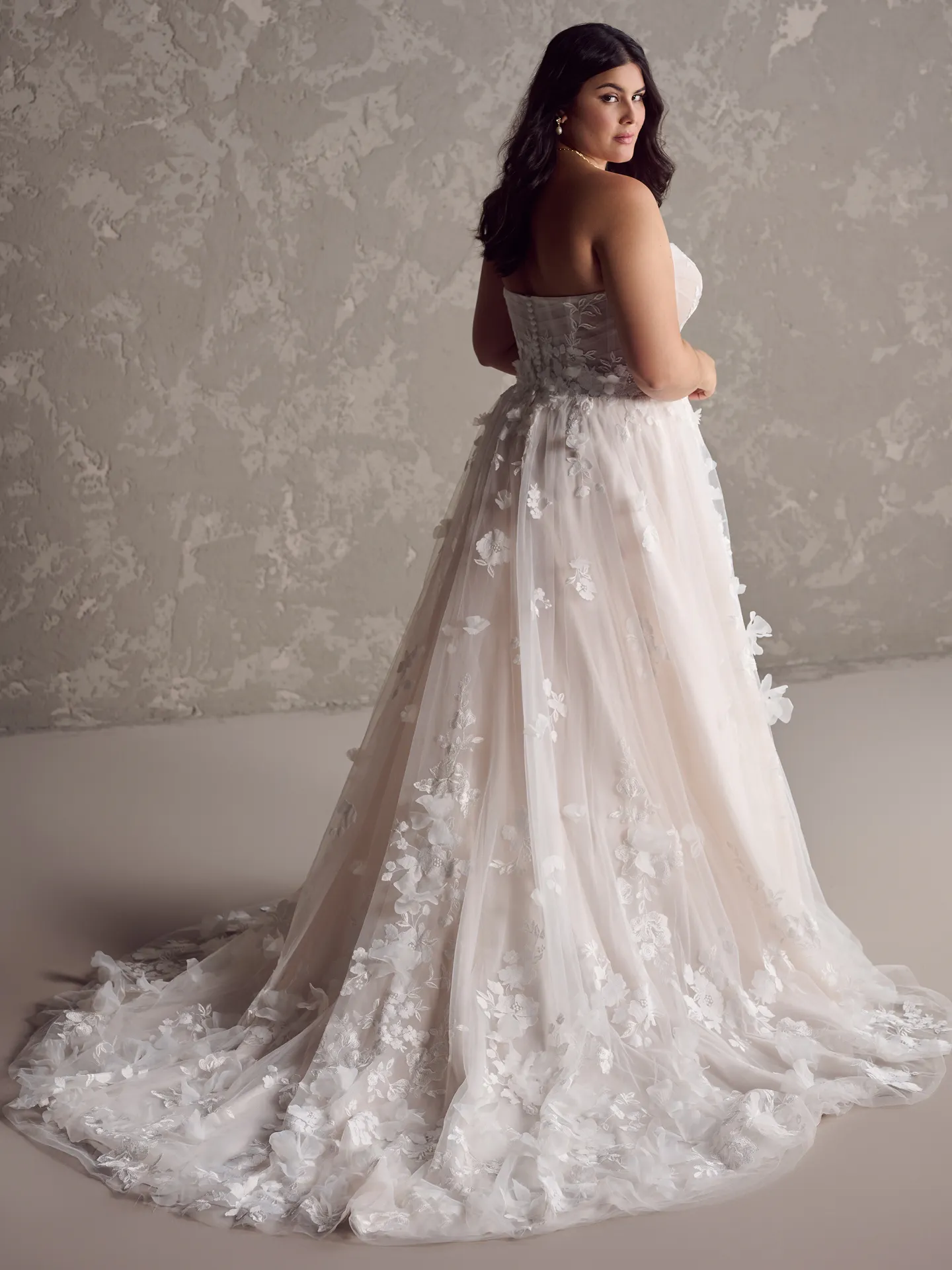 Maggie Sottero Laila back view with 3D floral design and long train