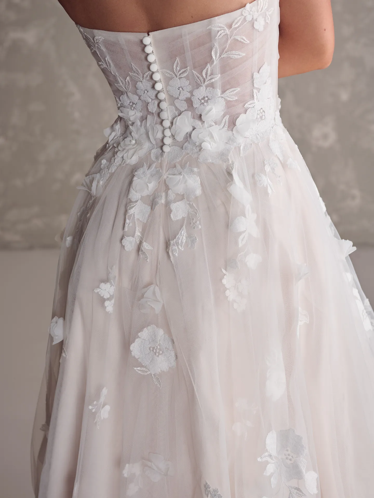 Maggie Sottero Laila back view, 3D floral gown with buttons
