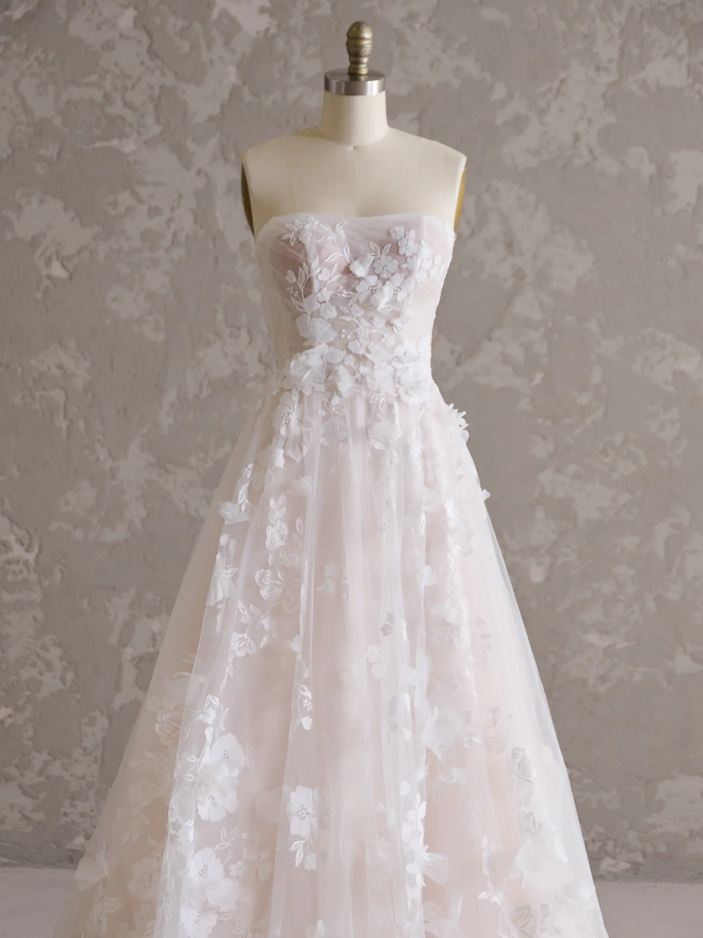 Maggie Sottero Laila floral wedding gown front view on mannequin.