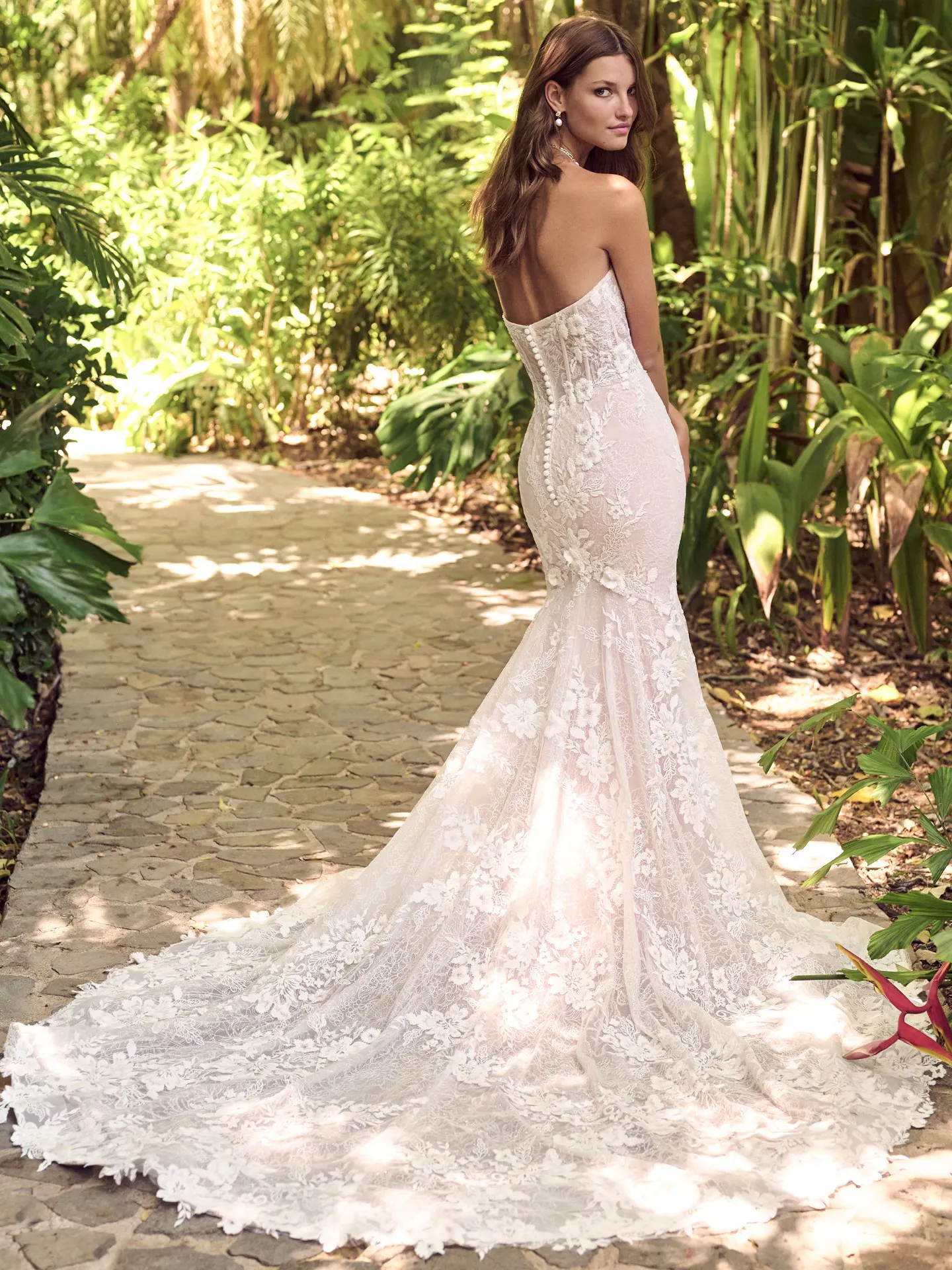 Ortensia back view lace bridal dress by Maggie Sottero in garden setting.