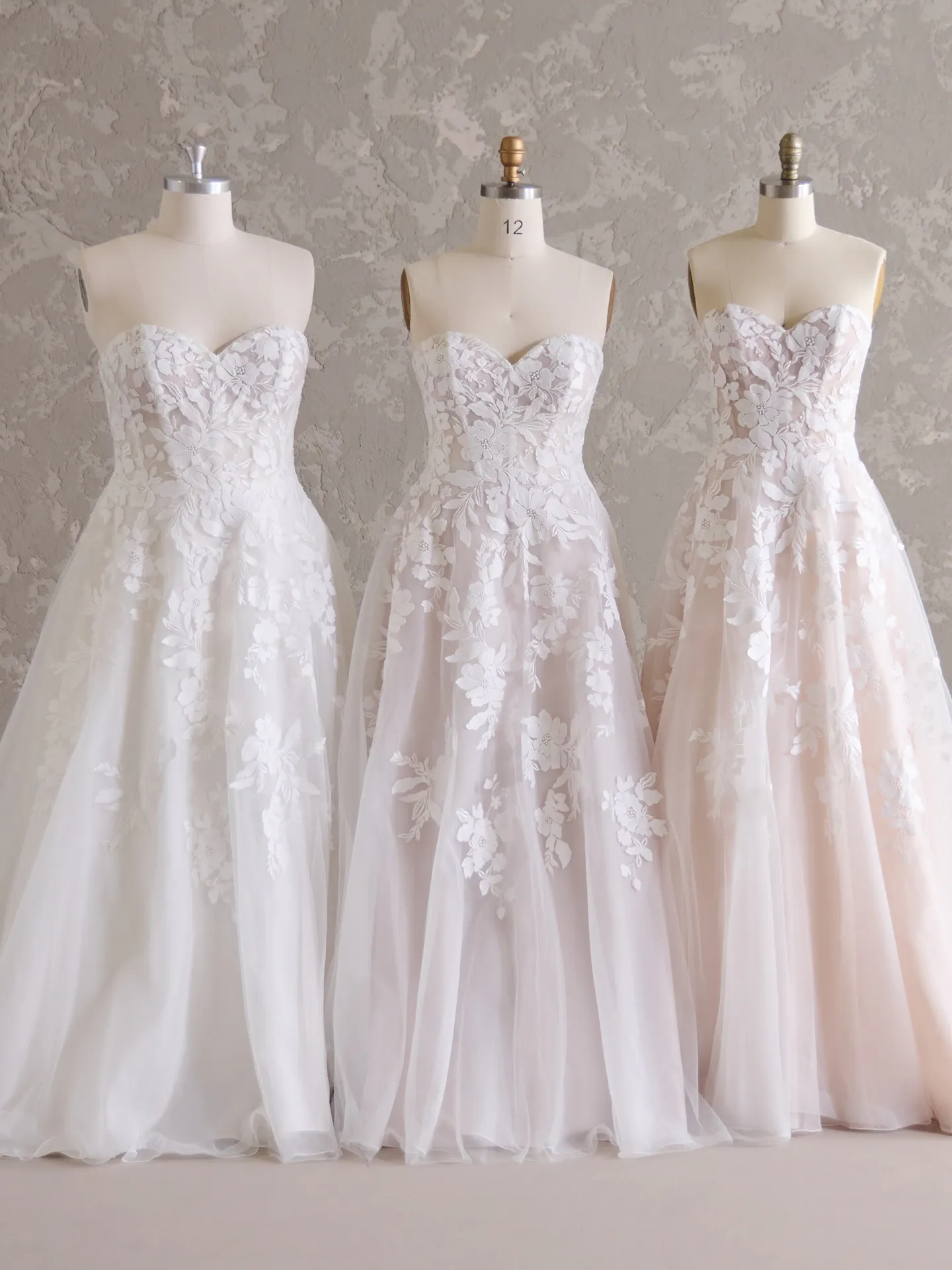 Rebecca Ingram Ruby A-Line gowns on mannequins, sweetheart necks, floral lace.
