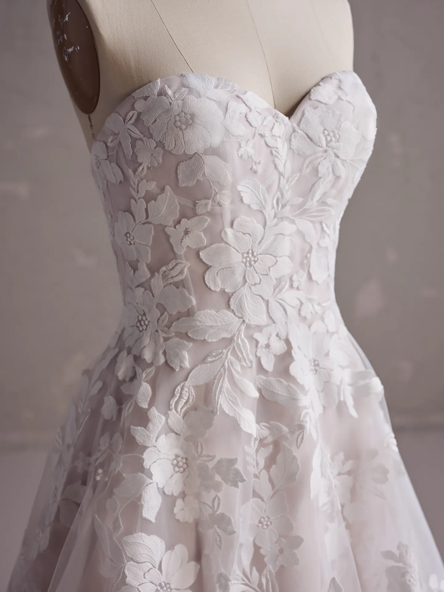 Rebecca Ingram Ruby A-Line wedding dress with floral lace detail, front view.