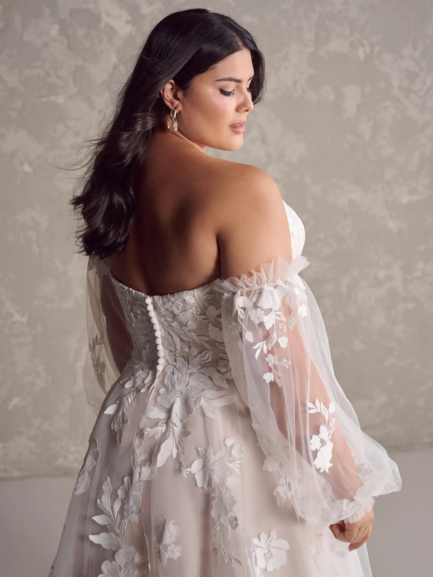 Rebecca Ingram Ruby back view, A-Line gown with floral lace and sheer sleeves