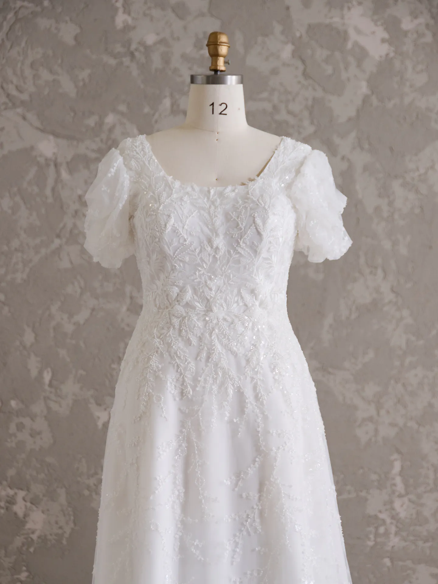 Rebecca Ingram Sonya Modest front view wedding dress on mannequin with scoop neckline
