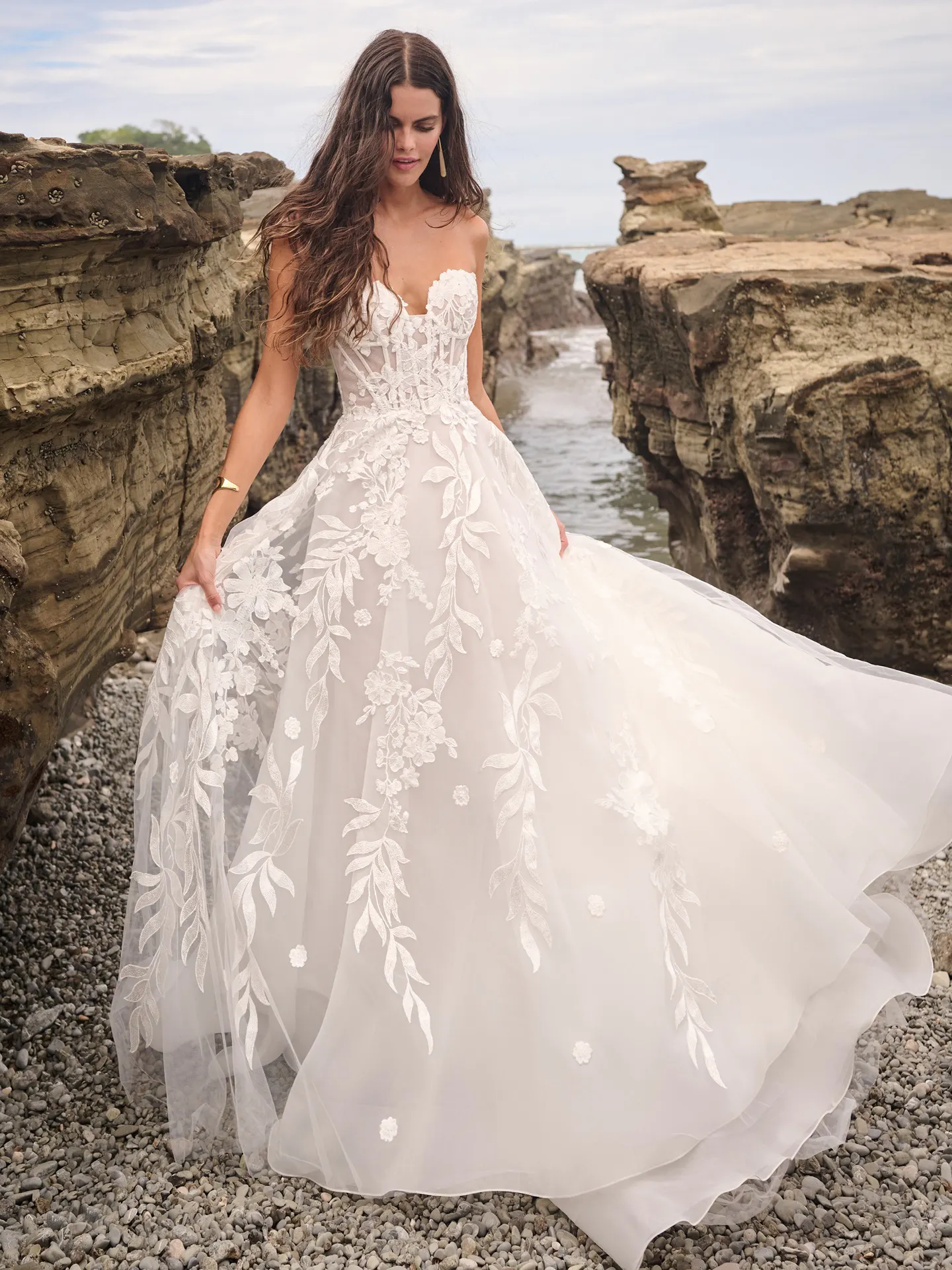 Sottero and Midgley Destin front view, corset A-line gown with floral lace on rocky beach