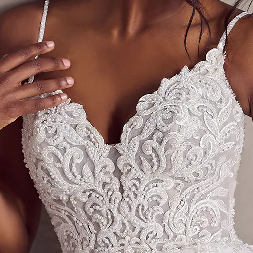 Rebecca Ingram Poppy close-up, intricate lace bodice with spaghetti straps, plus size wedding dress.