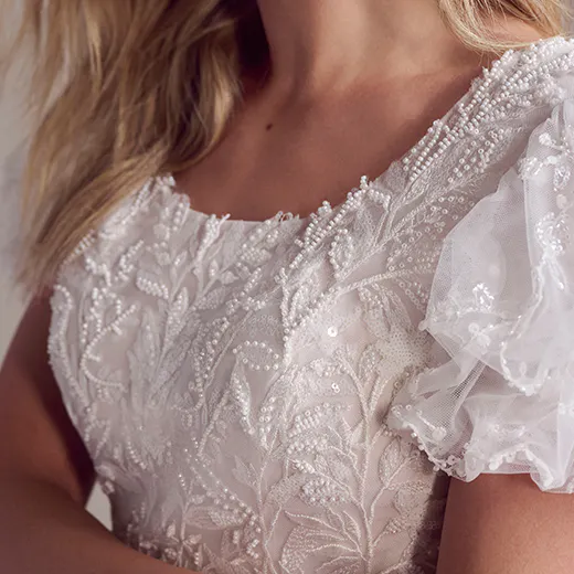 Rebecca Ingram Sonya scoop neckline close-up with lace and beading.