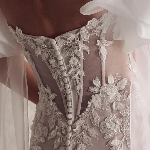 Sottero and Midgley Tanica back view, lace appliqué on sheer fabric with button details.
