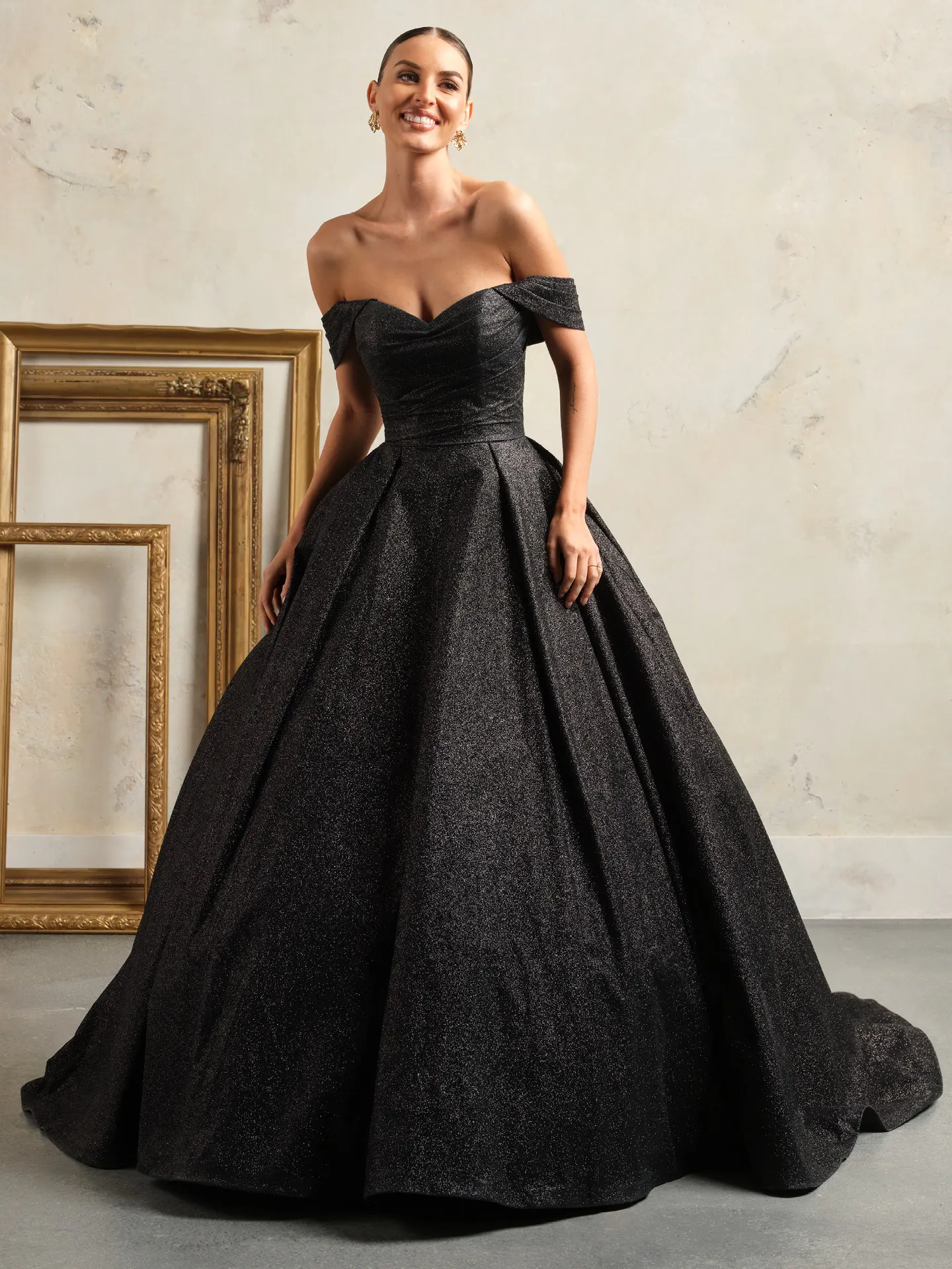 Maggie Sottero Anniston black ballgown front view with off-shoulder and shimmer details