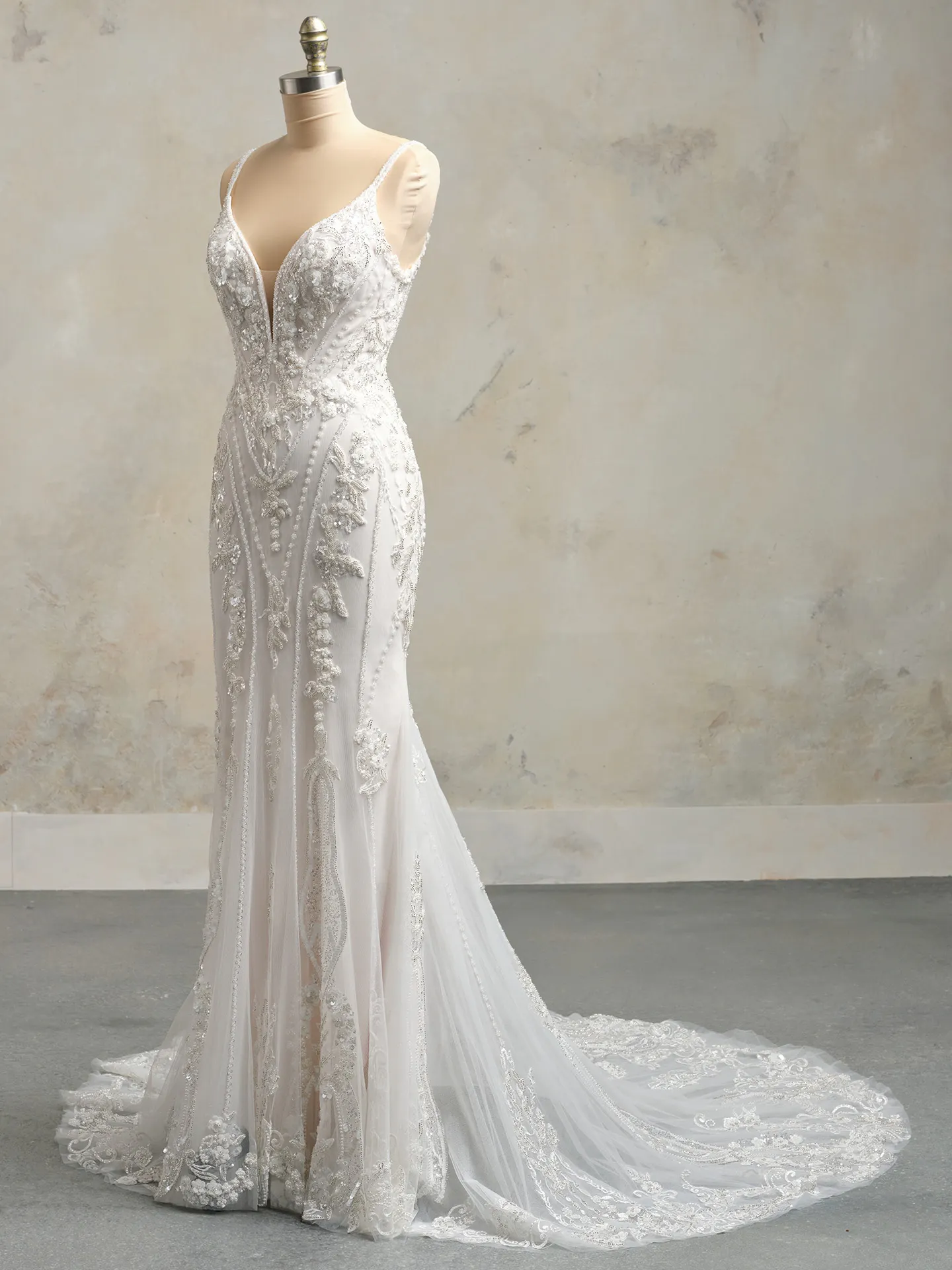 Maggie Sottero Edie gown side view with deep-V and glittering embellishments.