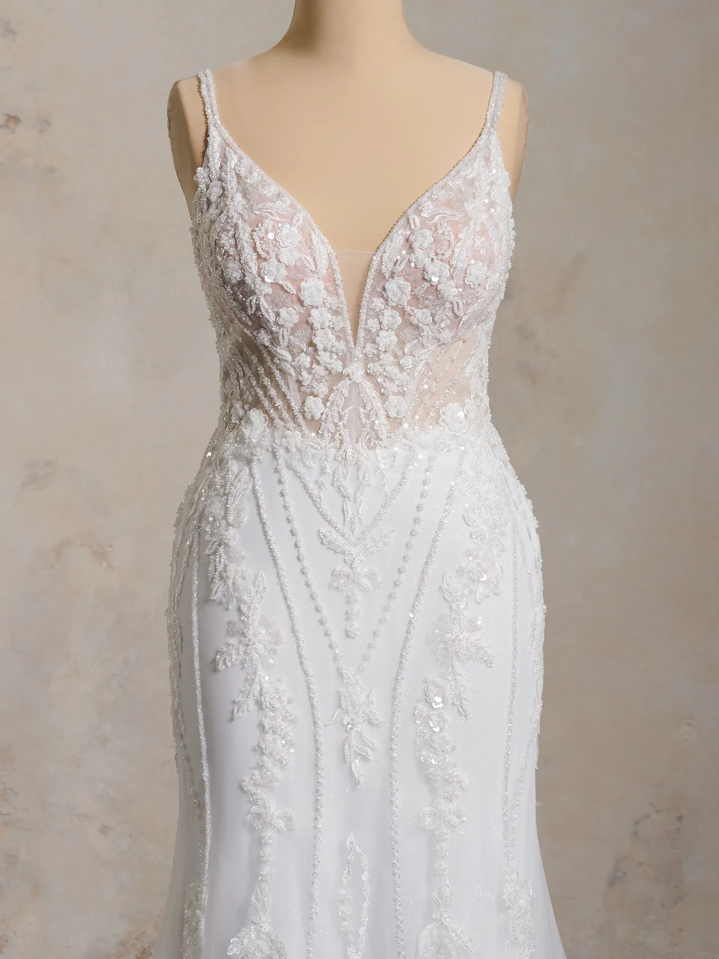 Maggie Sottero Edie gown front view with deep-V neckline and floral lace detailing.