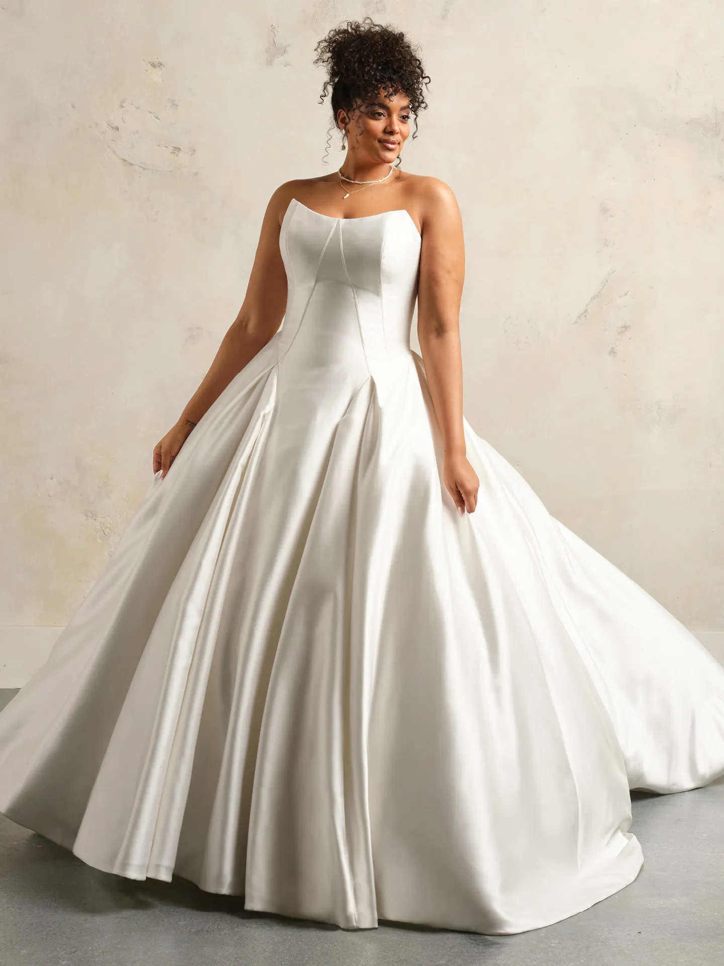 Rebecca Ingram ballgown front view, strapless satin dress with pleated skirt.