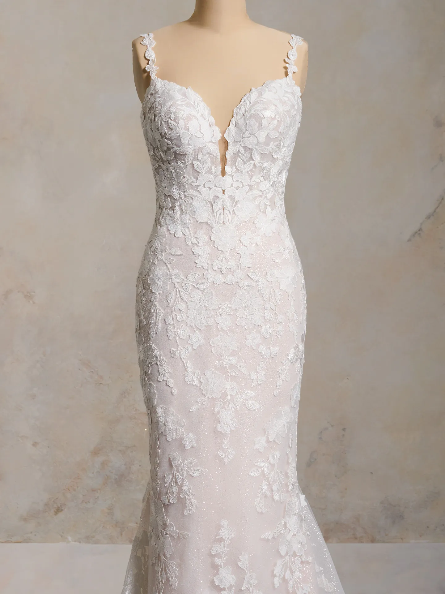 Maggie Sottero Hayden gown front view with floral lace and deep neckline.